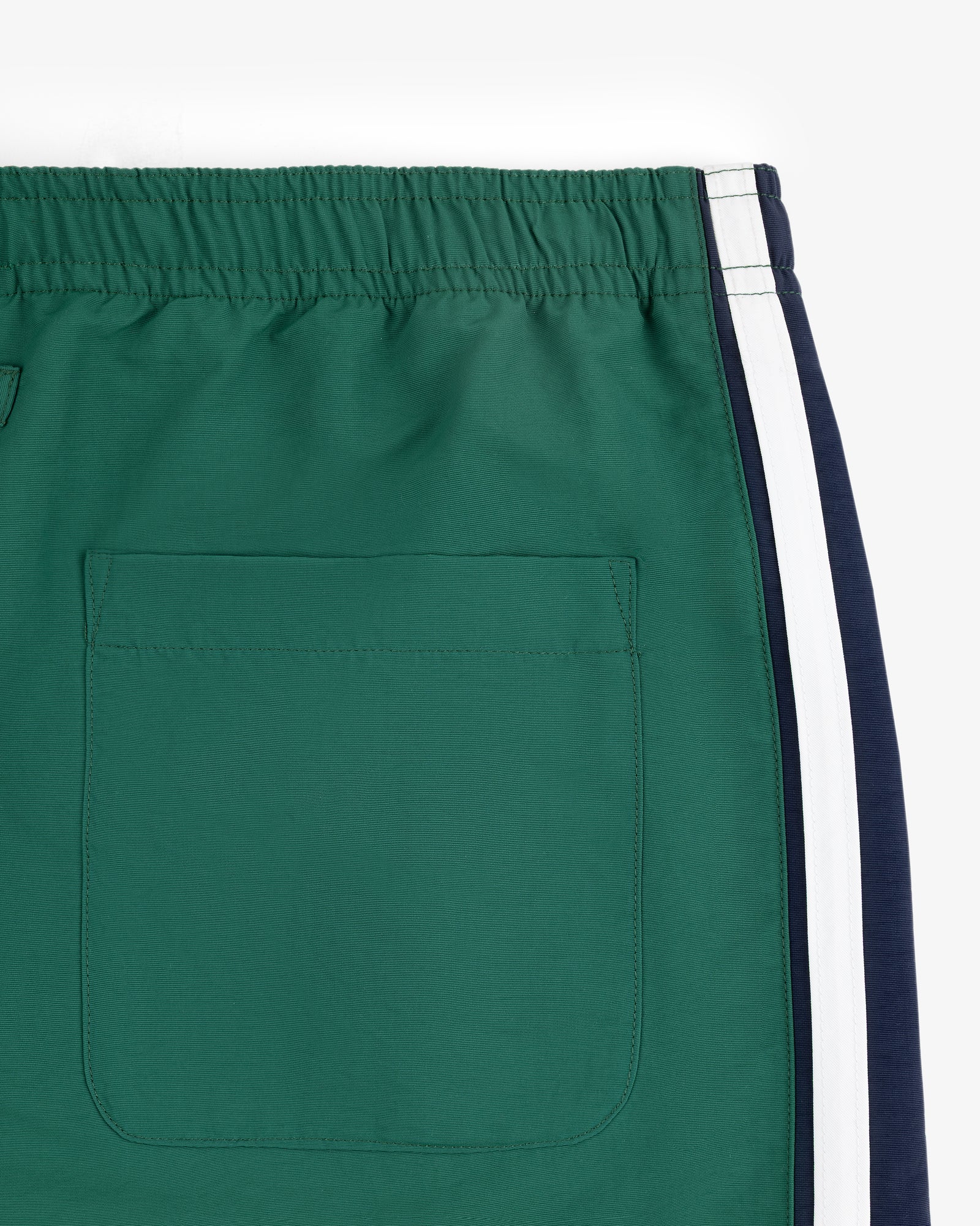 Colorblock Track Pant with elastic waistband, back pocket, and white/navy side stripes, on a white background.