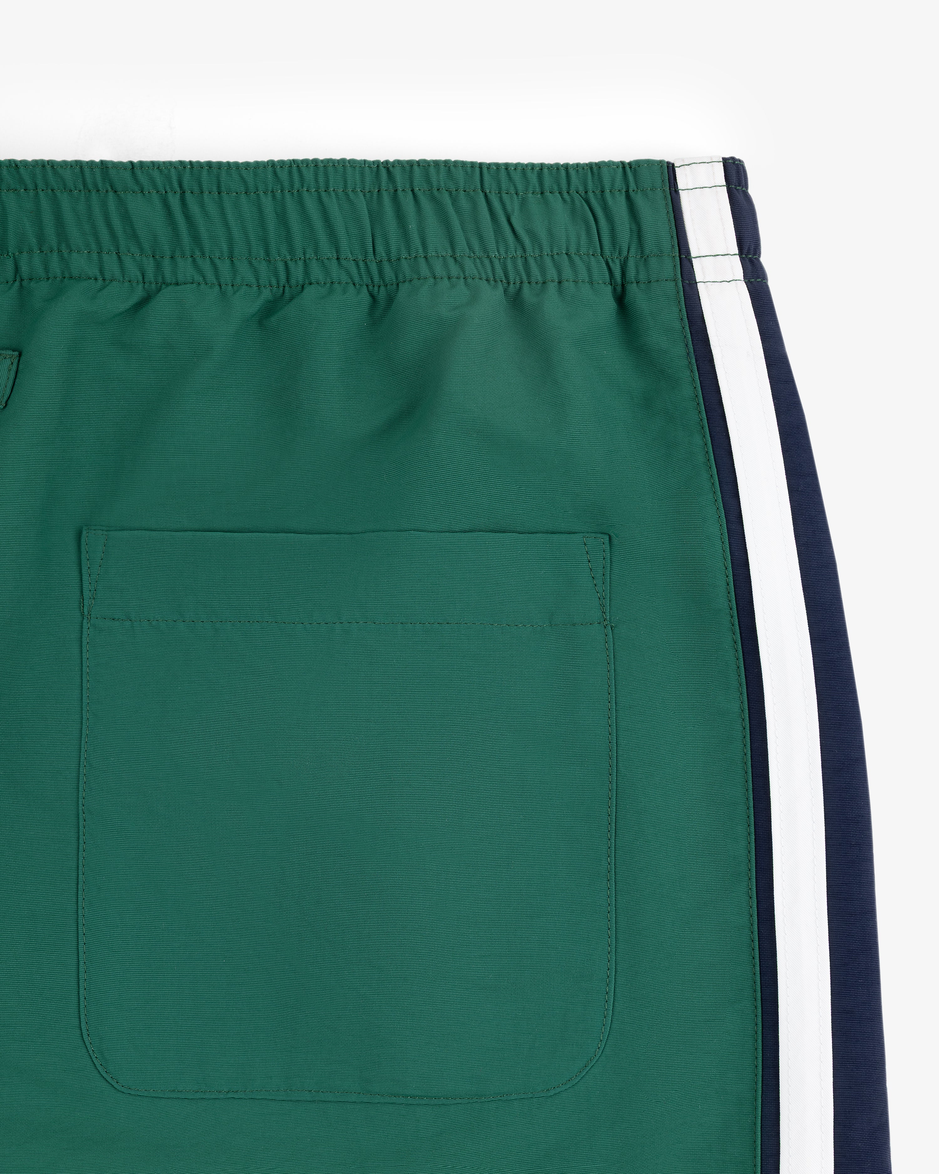 Colorblock Track Pant with elastic waistband, back pocket, and white/navy side stripes, on a white background.