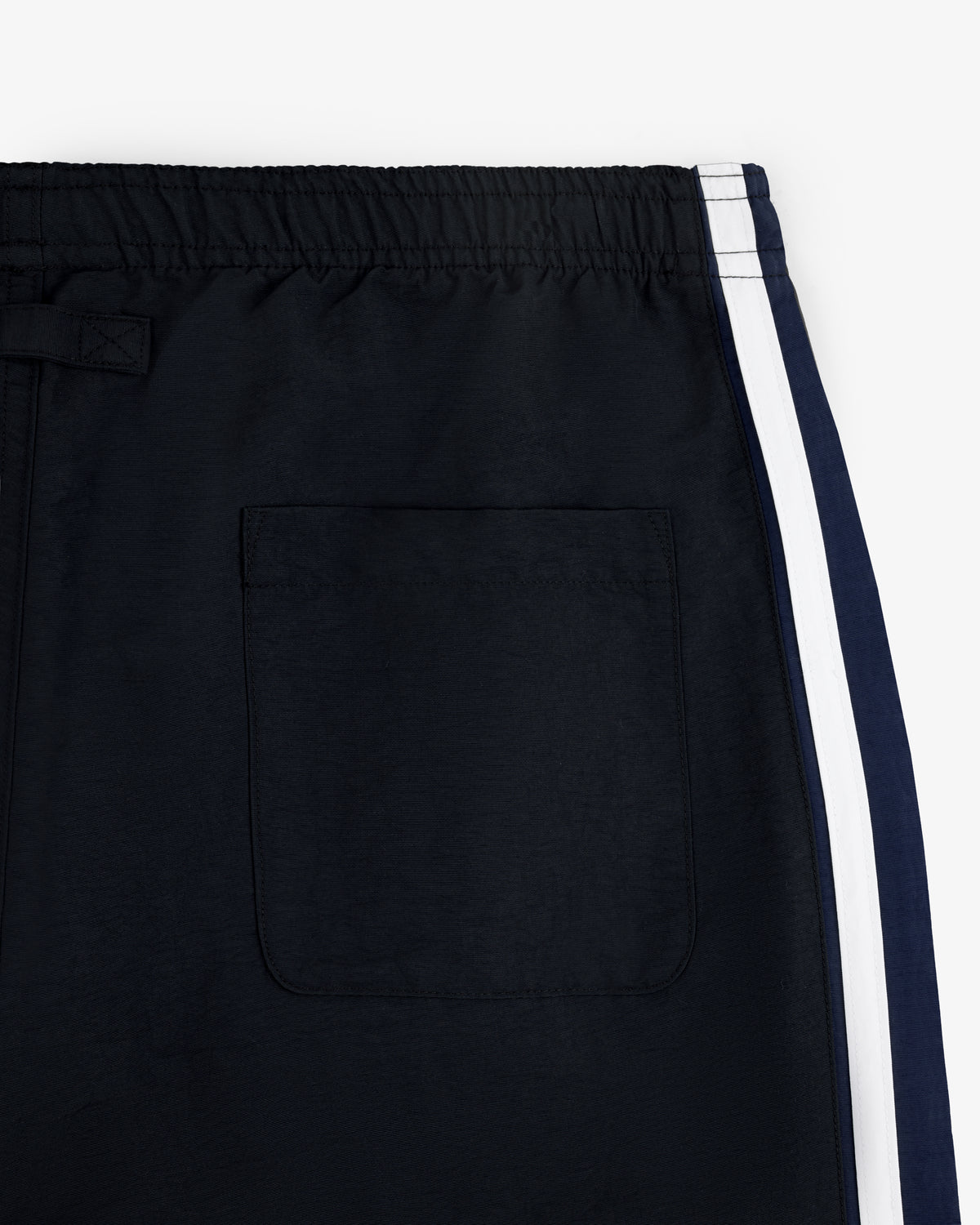 Close-up of Colorblock Track Pant with elastic waistband, white side stripe, and back pocket.