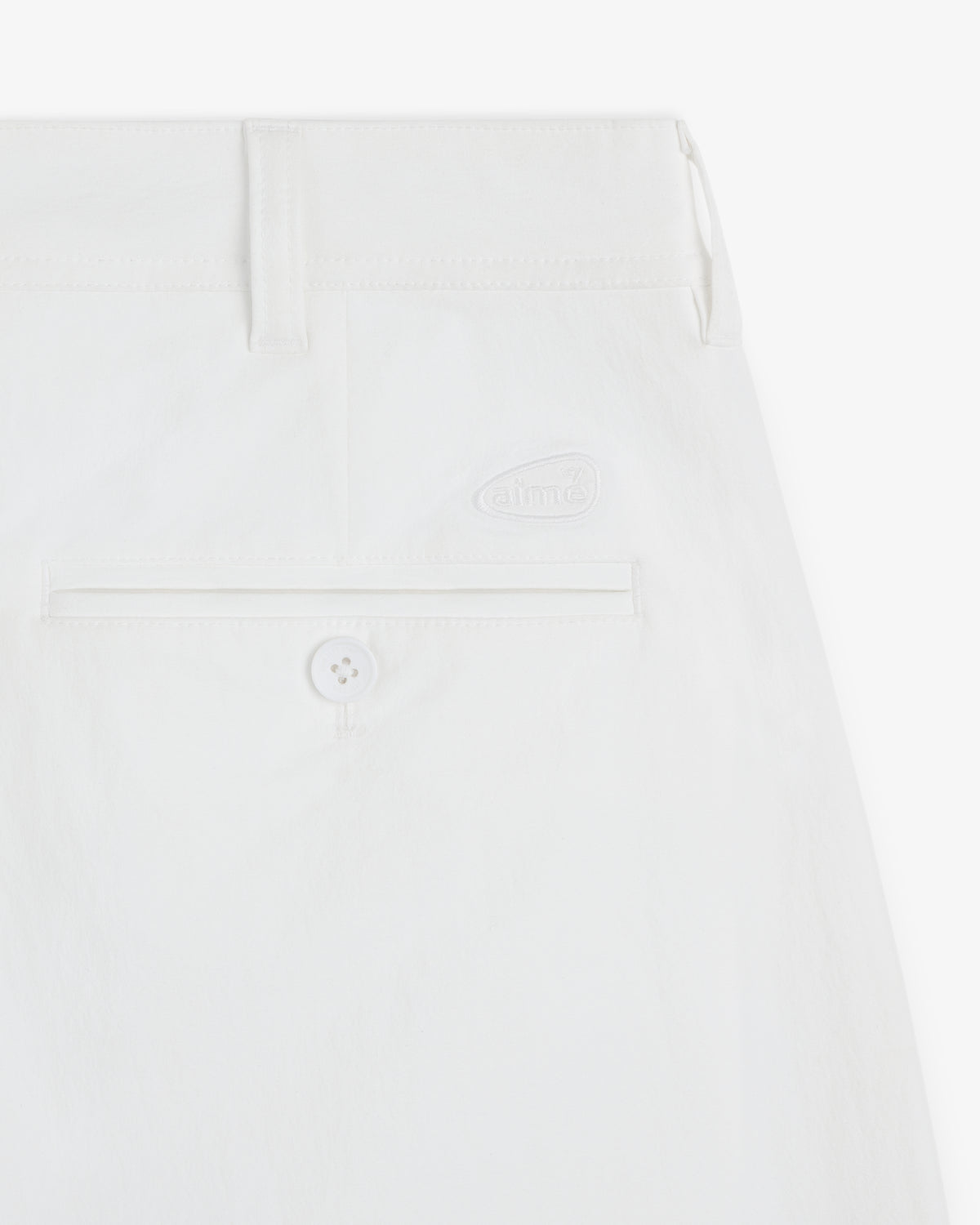Close-up of the back pocket and waistband of ALD Golf Cordura Double Pleated Pant featuring a button and subtle logo.