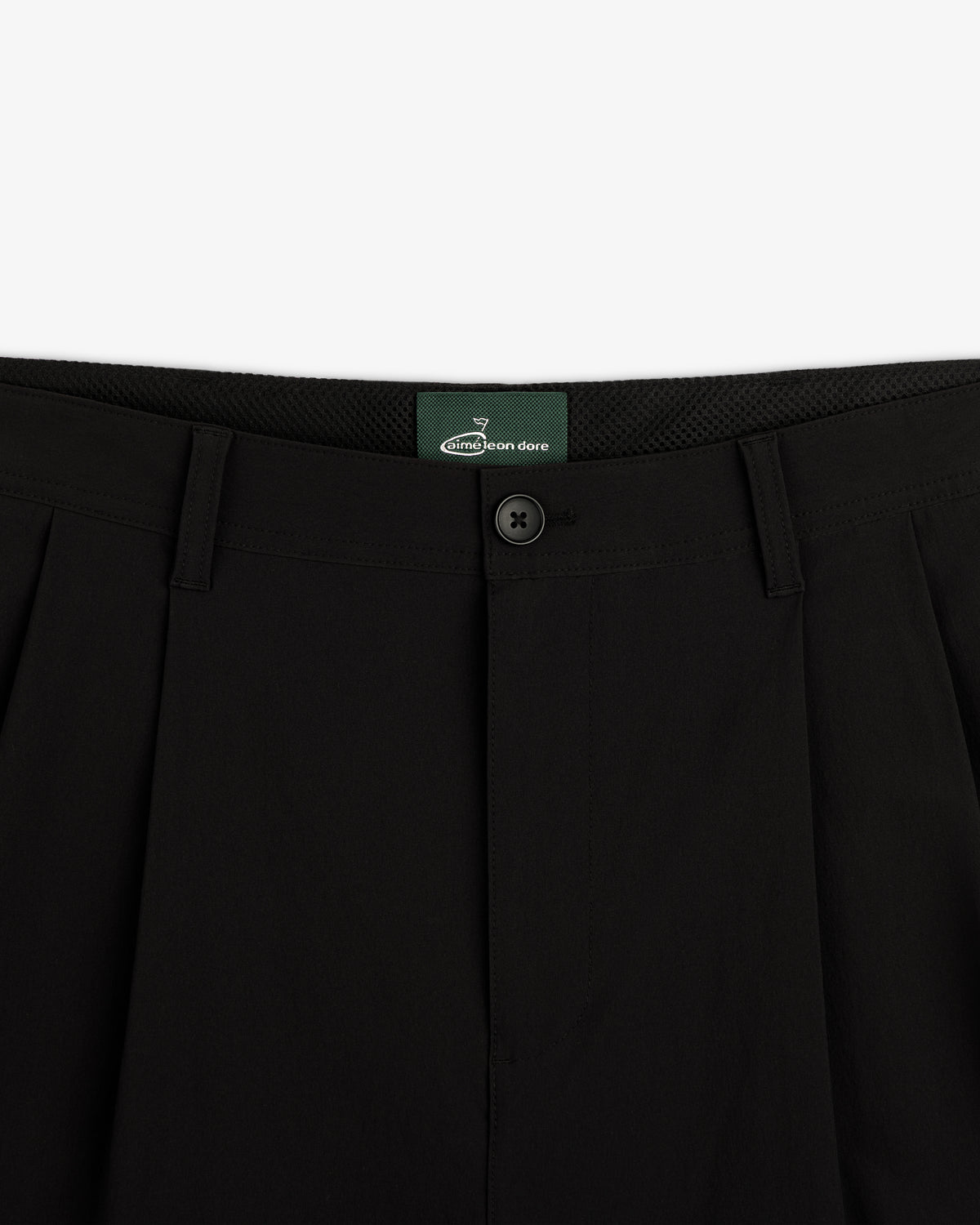 Close-up of the waistband and button on ALD Golf Cordura Double Pleated Pant in black, shown against a white background.