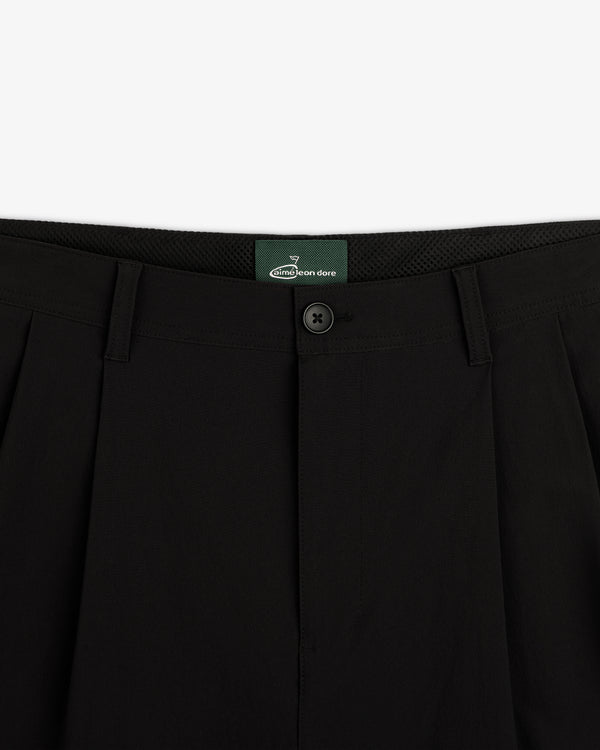 Close-up of the waistband and button on ALD Golf Cordura Double Pleated Pant in black, shown against a white background.