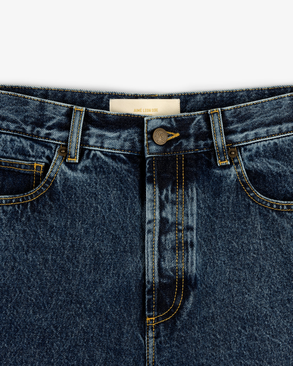 Close-up of Relaxed Fit 5-Pocket Denim Pant in blue with button closure, front pockets, and yellow stitching.
