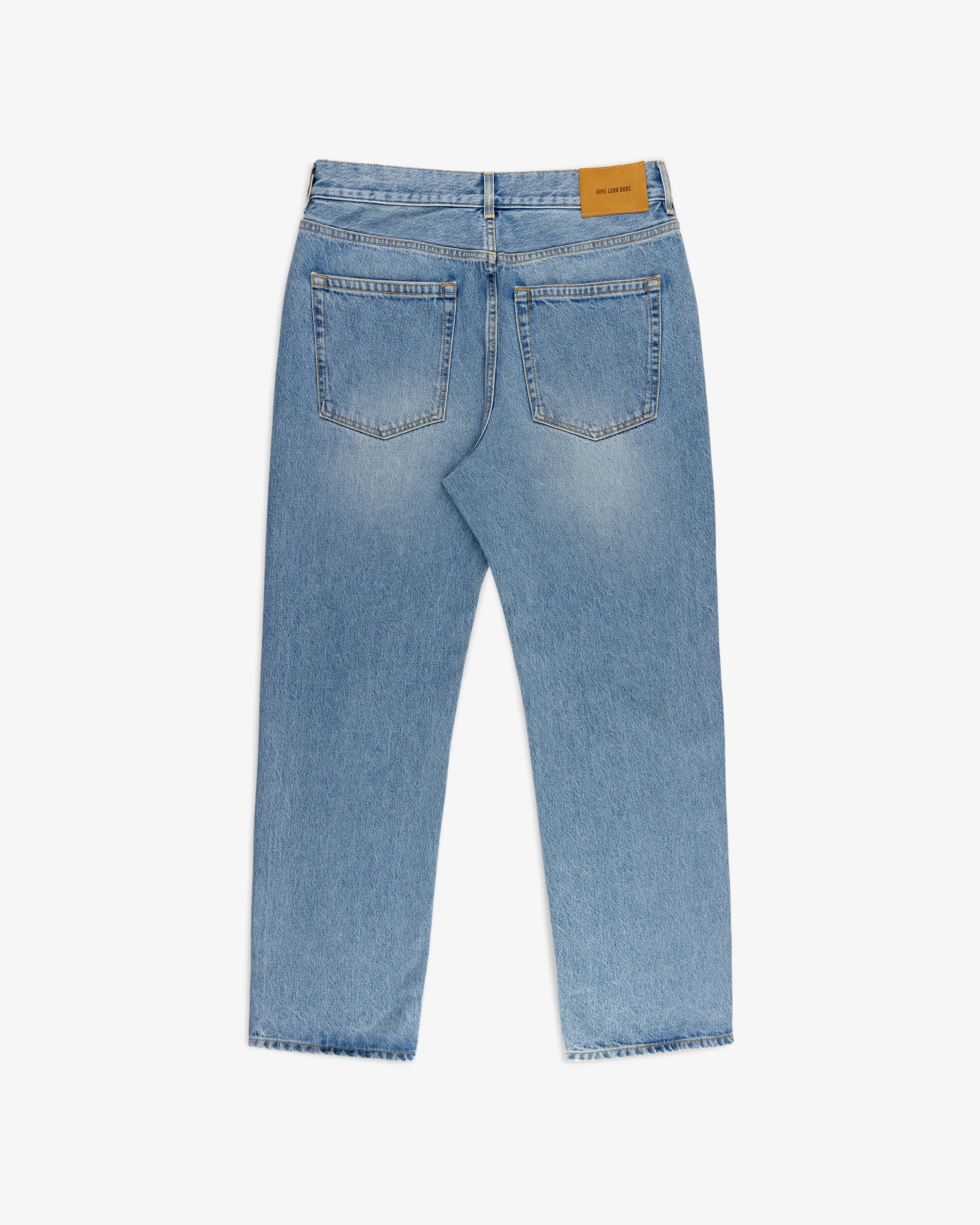 ALD Straight Fit Denim in light blue, back view with two pockets and a tan leather patch on the waistband.