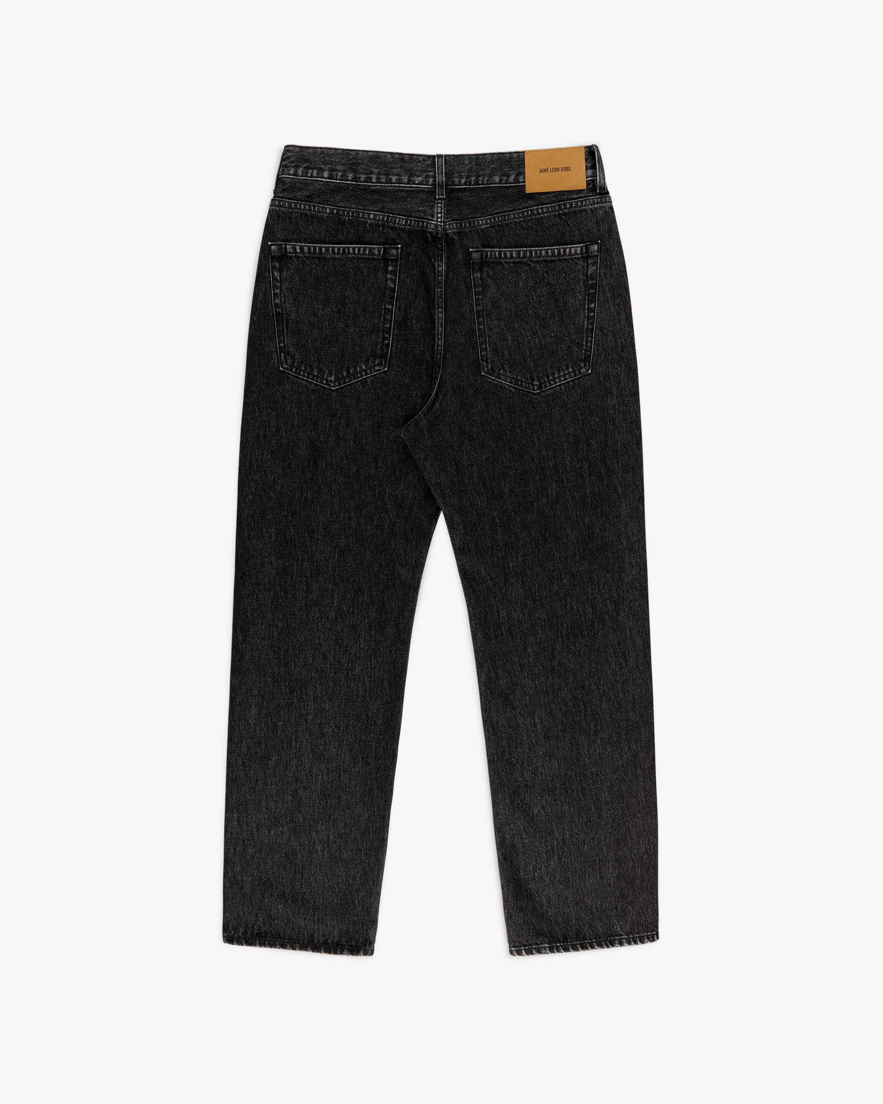Back view of Relaxed Fit 5-Pocket Denim Pant in black with two pockets and a tan leather patch on the waistband.