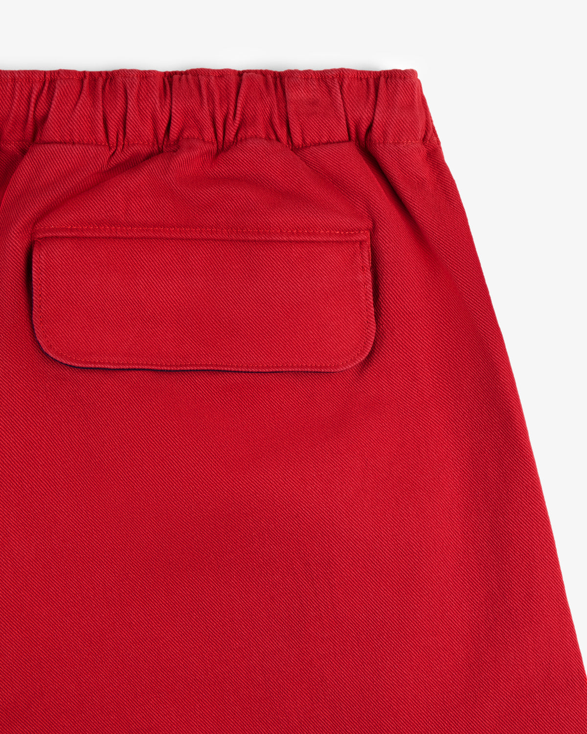 Close-up of Crest Casual Short in red featuring an elastic waistband and a back flap pocket.