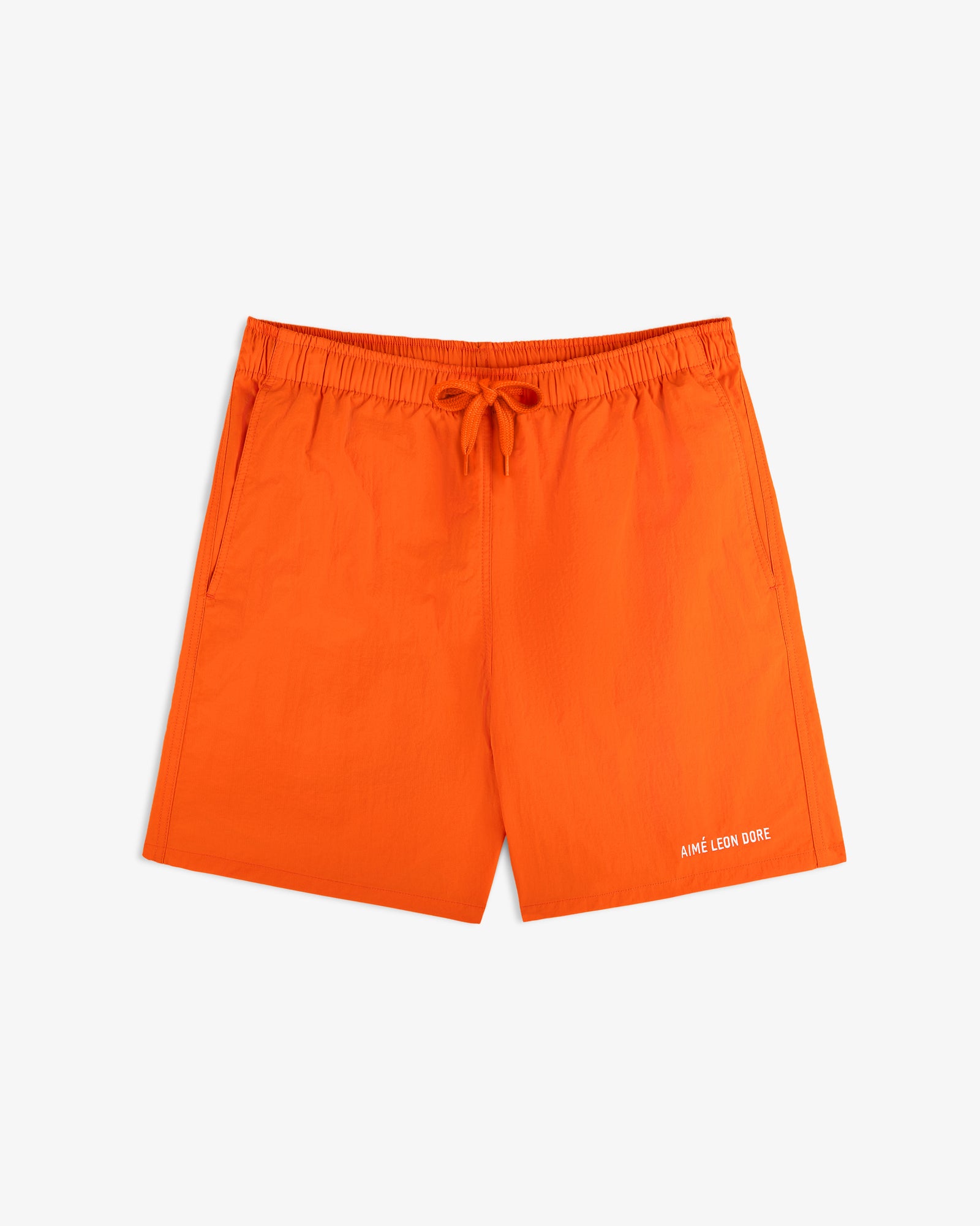 Bright orange Logo Swim Short with drawstring waist, side pockets, and Aime Leon Dore text on the front left hem.