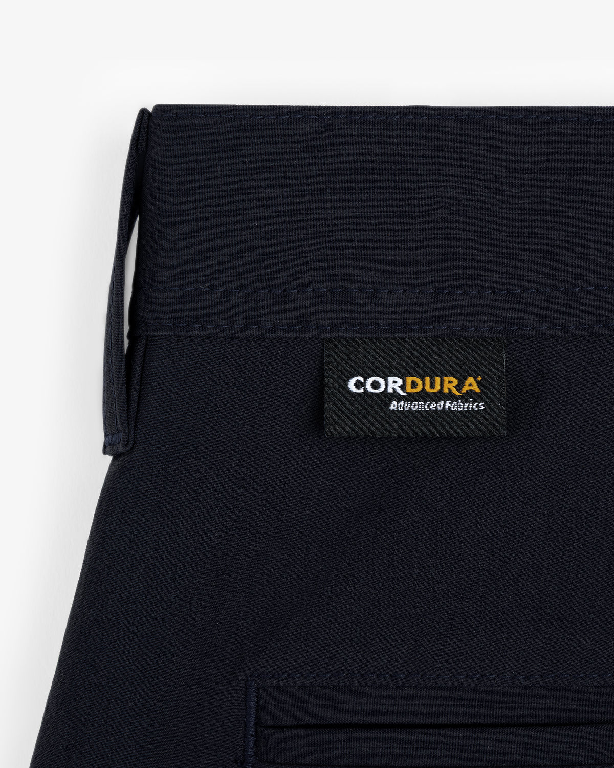 Close-up of ALD Golf Cordura Double Pleated Short with a black “CORDURA Advanced Fabrics” label above the pocket.