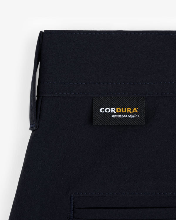 Close-up of ALD Golf Cordura Double Pleated Short with a black “CORDURA Advanced Fabrics” label above the pocket.