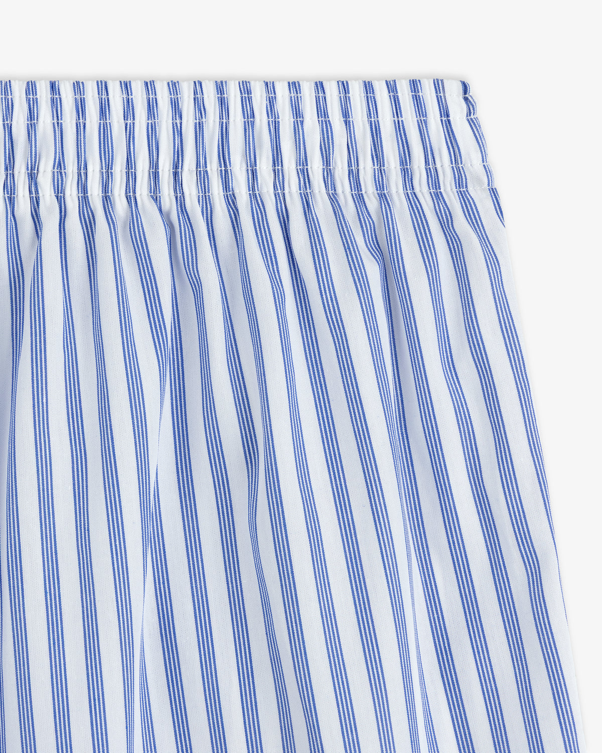 Close-up of blue and white vertical striped fabric with an elastic waistband on a Striped Boxer Short.