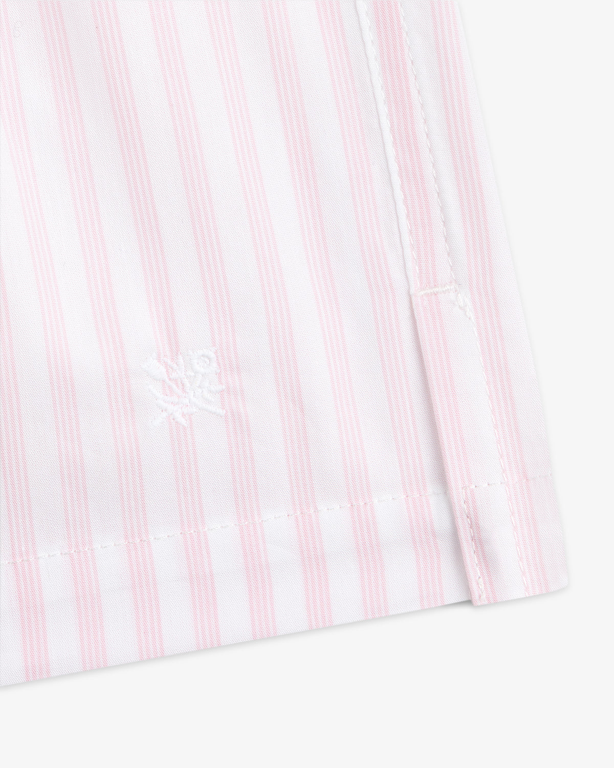 Close-up of Striped Boxer Short featuring pink and white vertical stripes and a white embroidered logo near the hem.