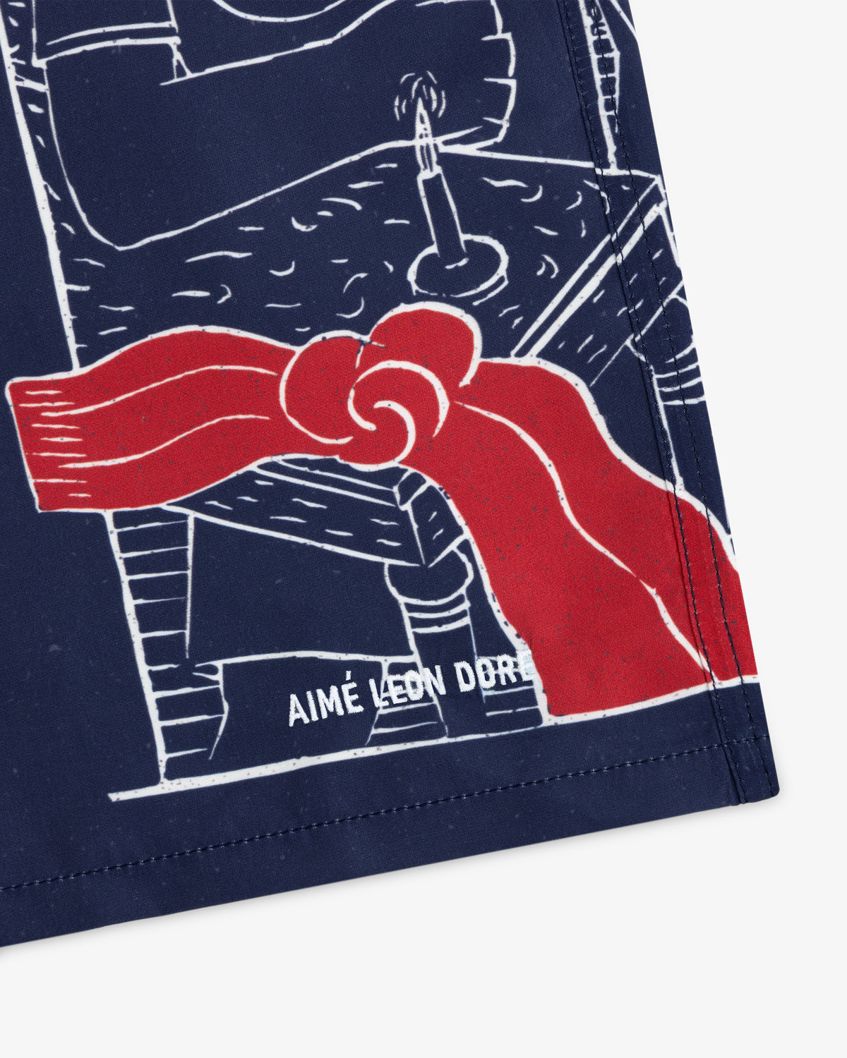 Illustration of Fassianos "Nocturnal Love" Swim Short with a red ribbon, blue background, and hand-drawn candle on a table.