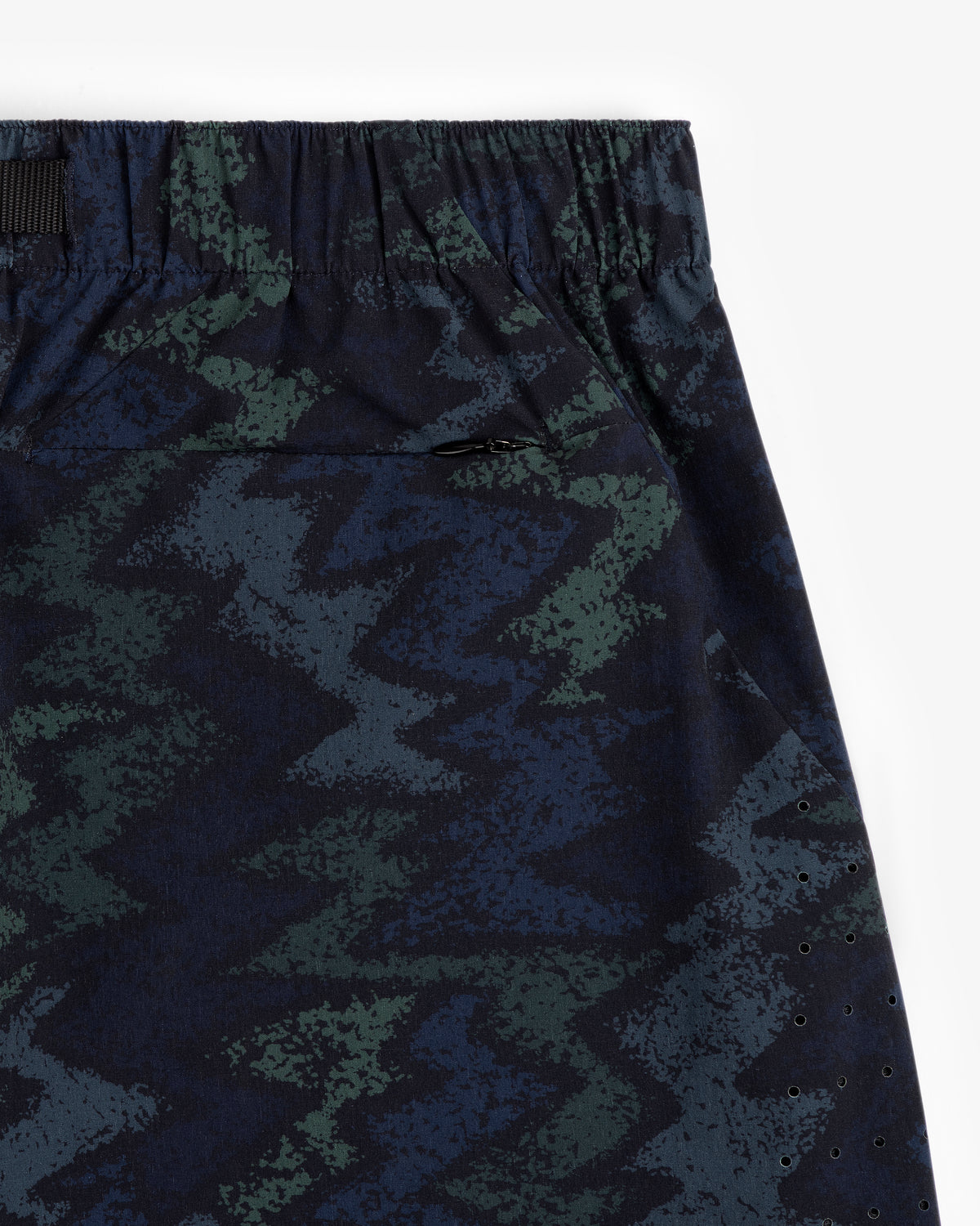 Close-up of ALD Golf Performance Short with zigzag green and blue pattern, elastic waistband, on white background.