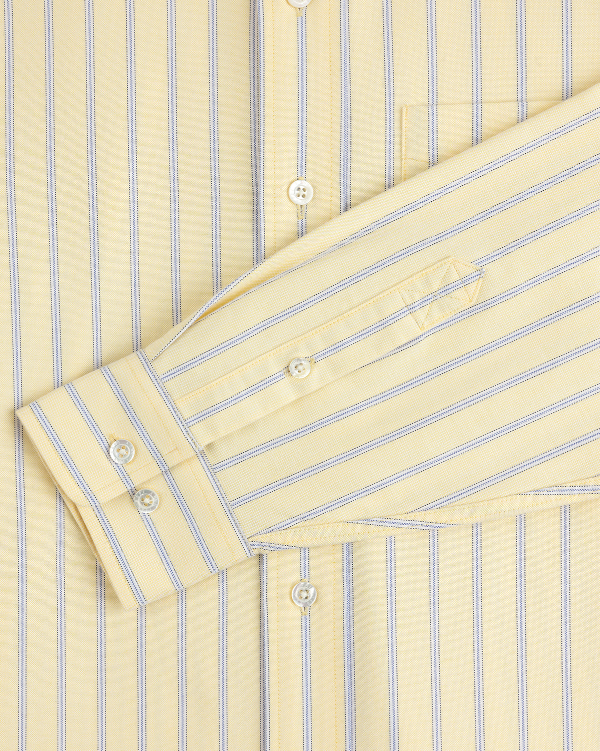 Yarn Dyed Striped Crest Shirt in yellow with blue stripes, close-up of sleeve, buttons, and pocket.