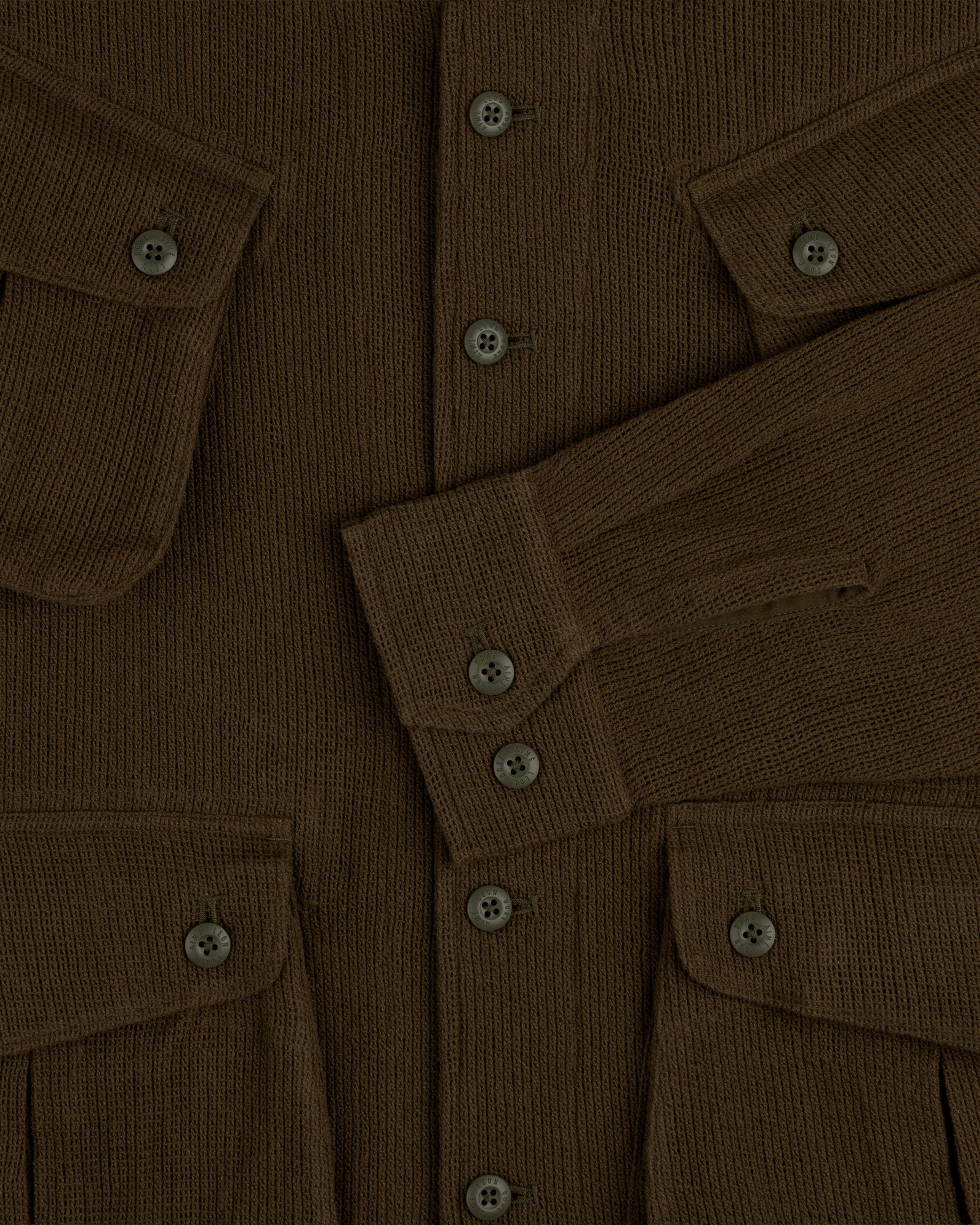 Mesh Jungle Shirt with buttoned front, flap pockets, and long sleeves overlapping at the center.