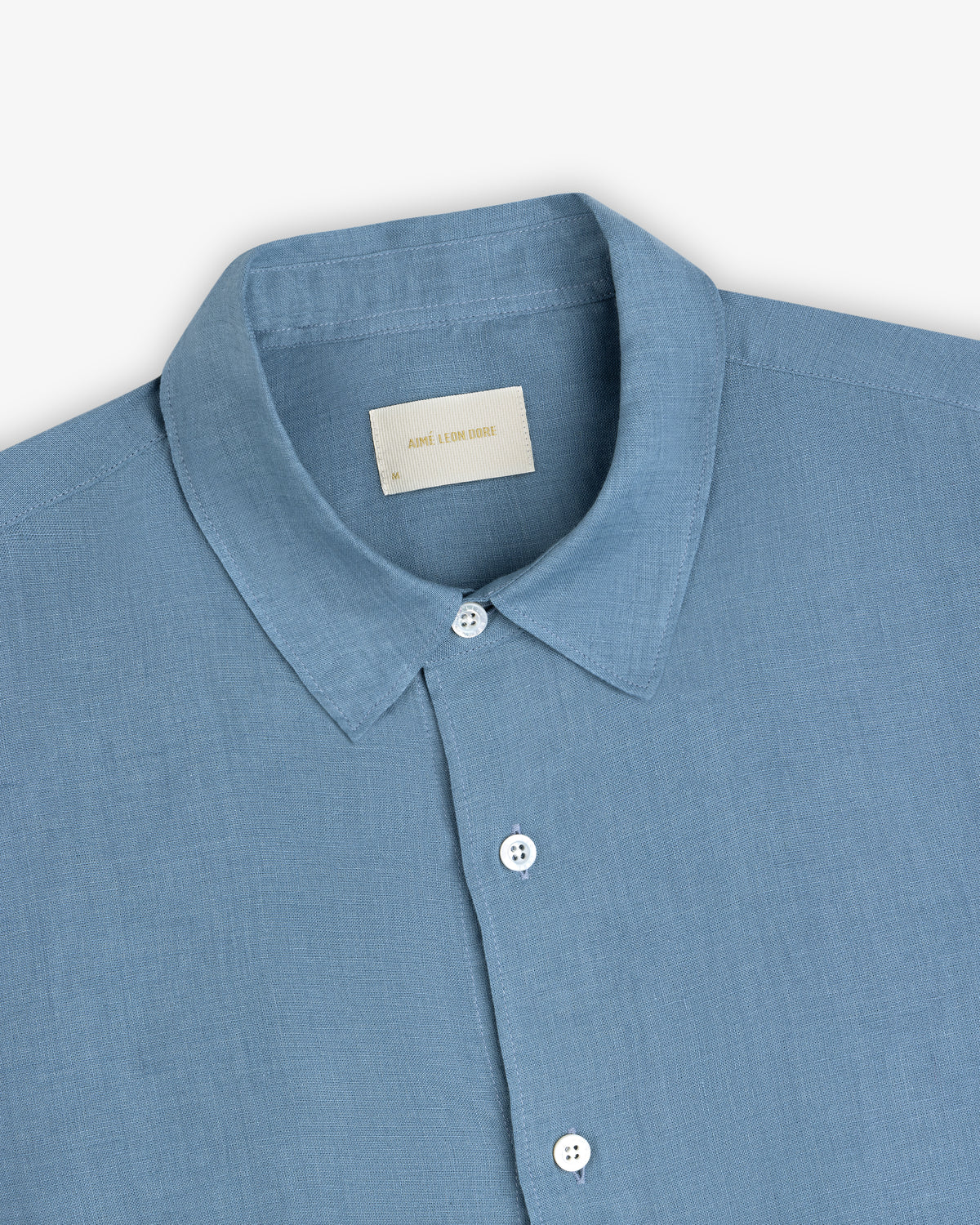 Light blue Long-Sleeve Linen Shirt with a pointed collar, white buttons, and visible neck label on plain background.