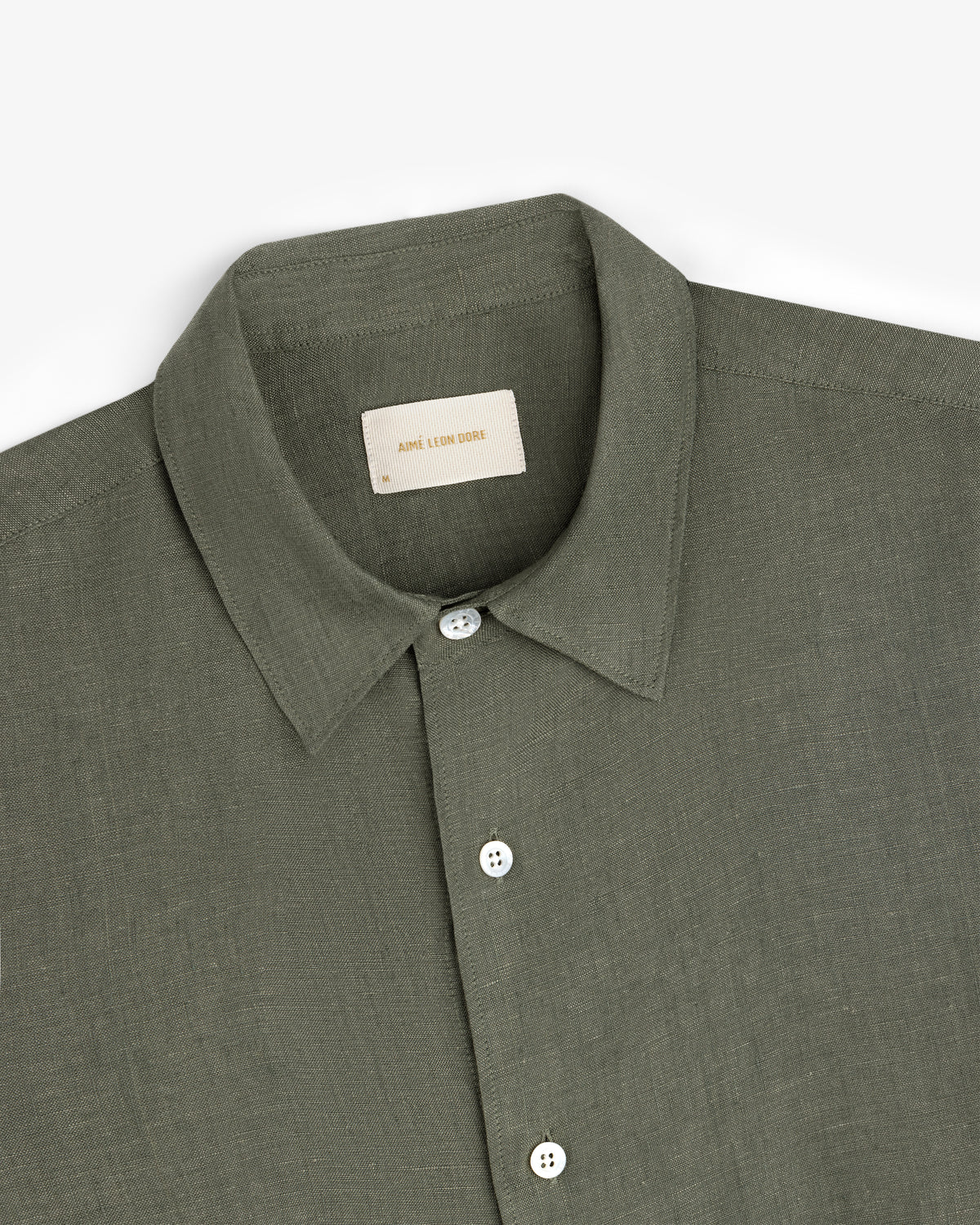 Olive green Long-Sleeve Linen Shirt with white buttons, folded on a white background.