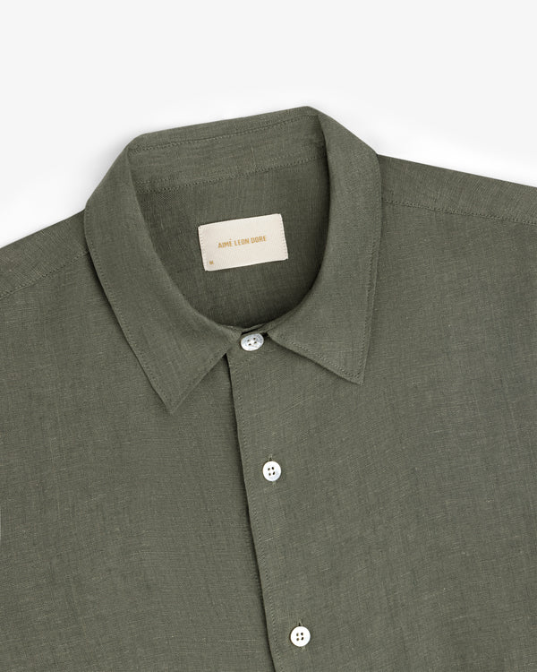 Olive green Long-Sleeve Linen Shirt with white buttons, folded on a white background.