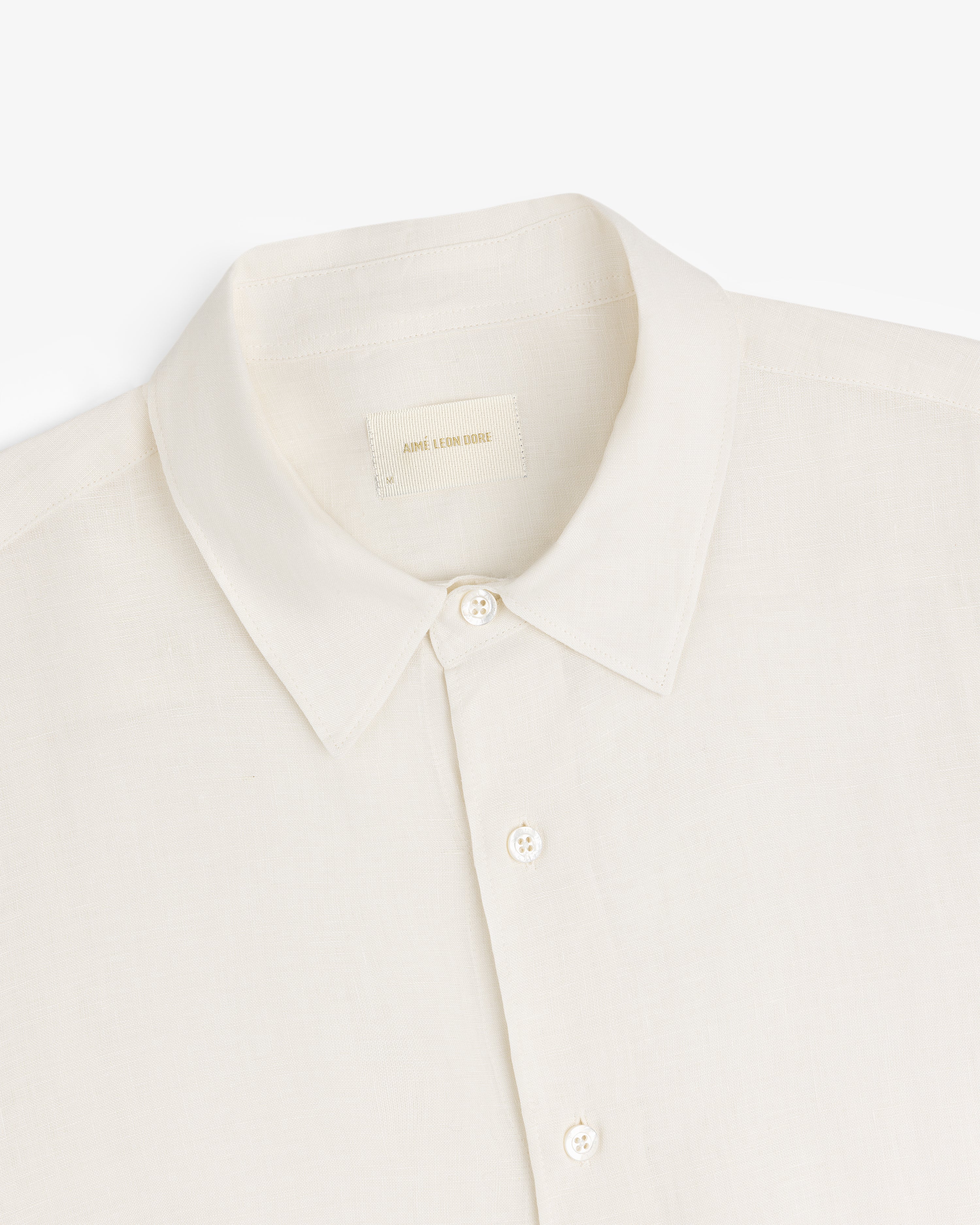 Long-Sleeve Linen Shirt in cream with collar and buttons, shown top front on a white background.