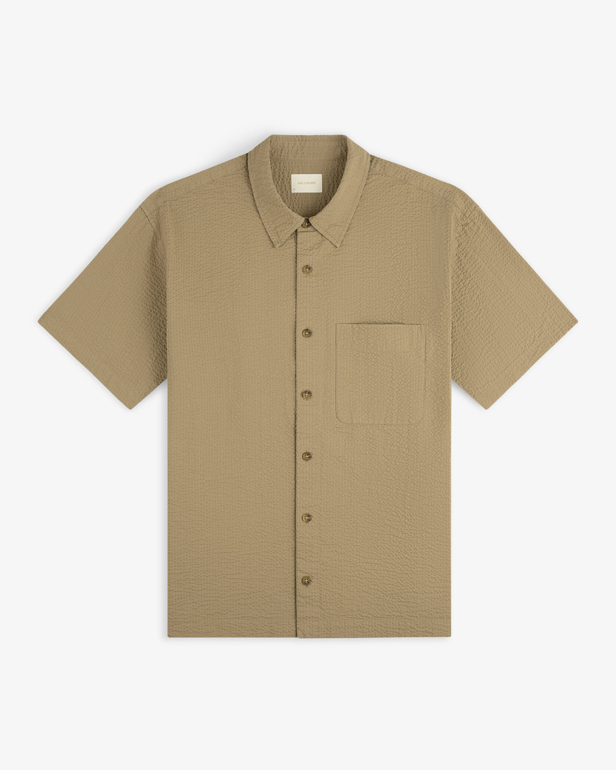 Short-Sleeve Seersucker Shirt in textured beige with front chest pocket, laid flat on a white background.