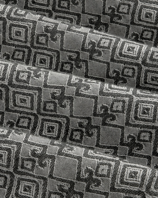 Jacquard Leisure Shirt in black and gray fabric features a geometric square pattern, shown with overlapping folds.