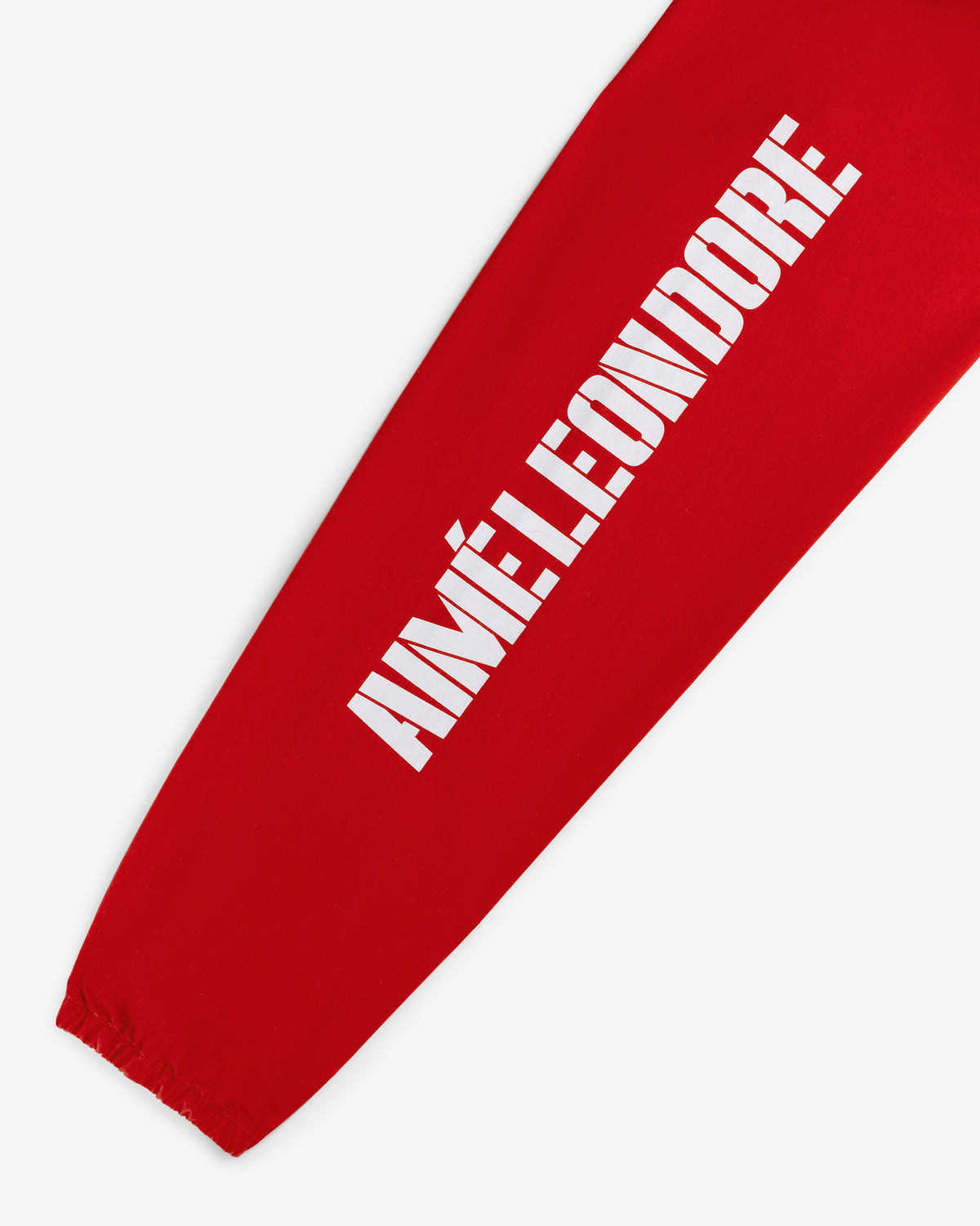 Red sleeve of the Marina Jacket with bold white AIMÉ LEON DORE text printed vertically along the arm.