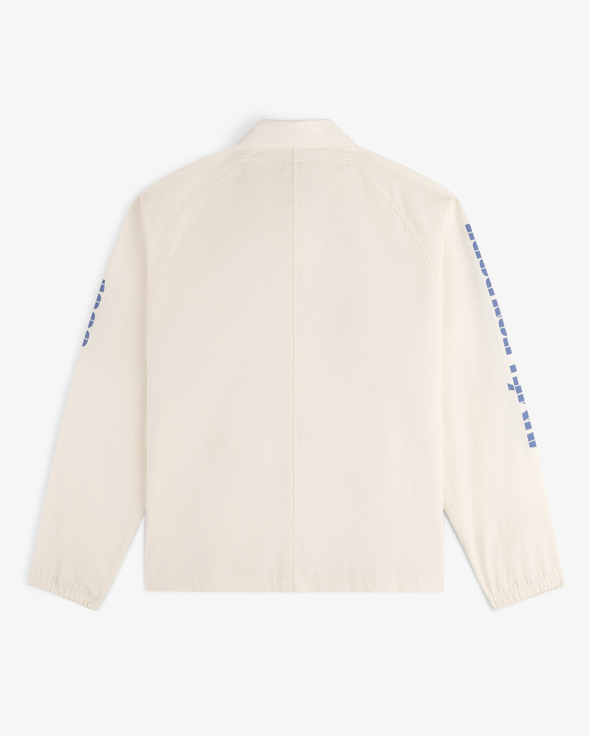 Back view of the Marina Jacket, a light beige long-sleeve with blue square designs on the sleeves.