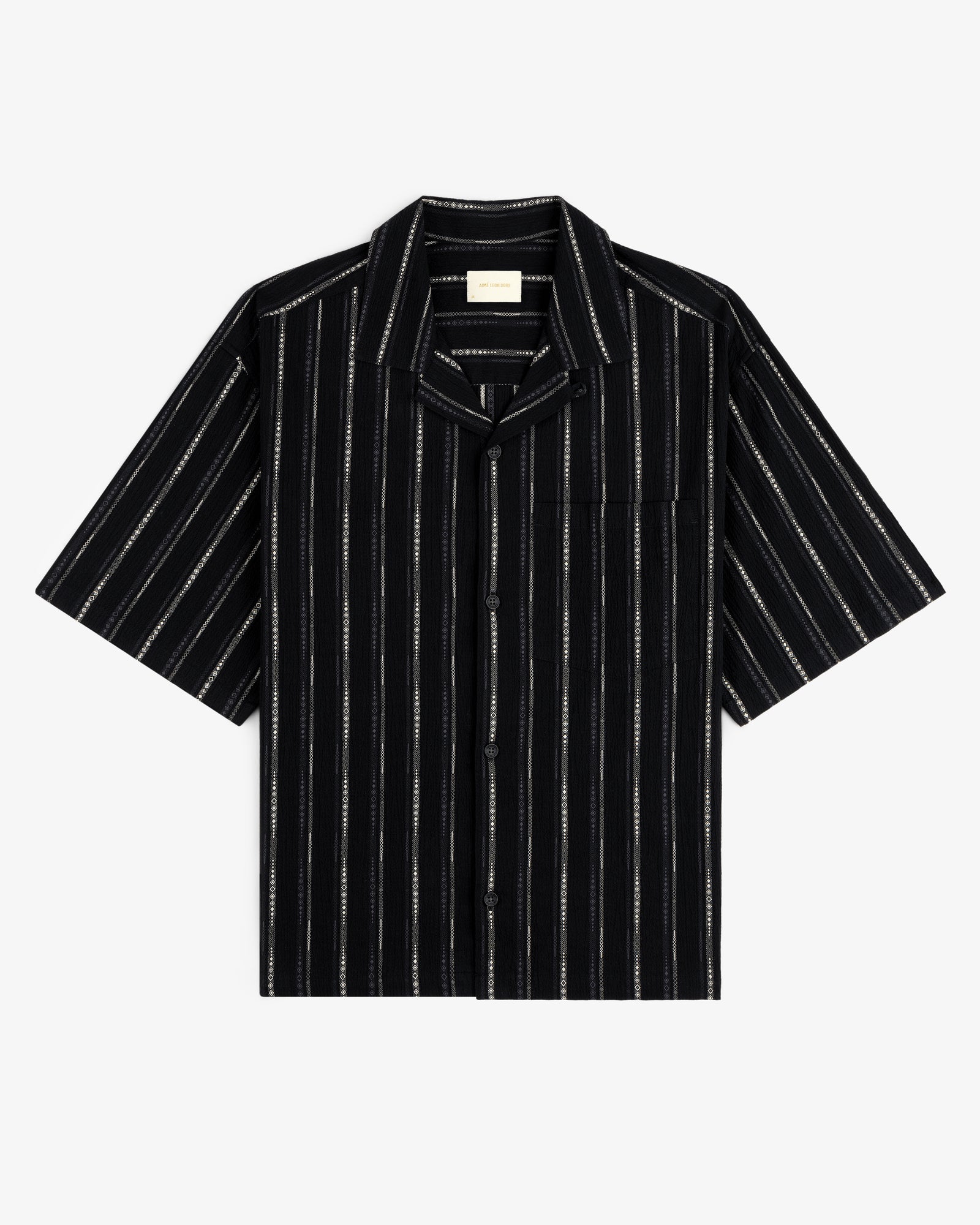 Cropped Jacquard Camp Shirt in black with white vertical stripes, chest pocket, and short sleeves, laid flat.