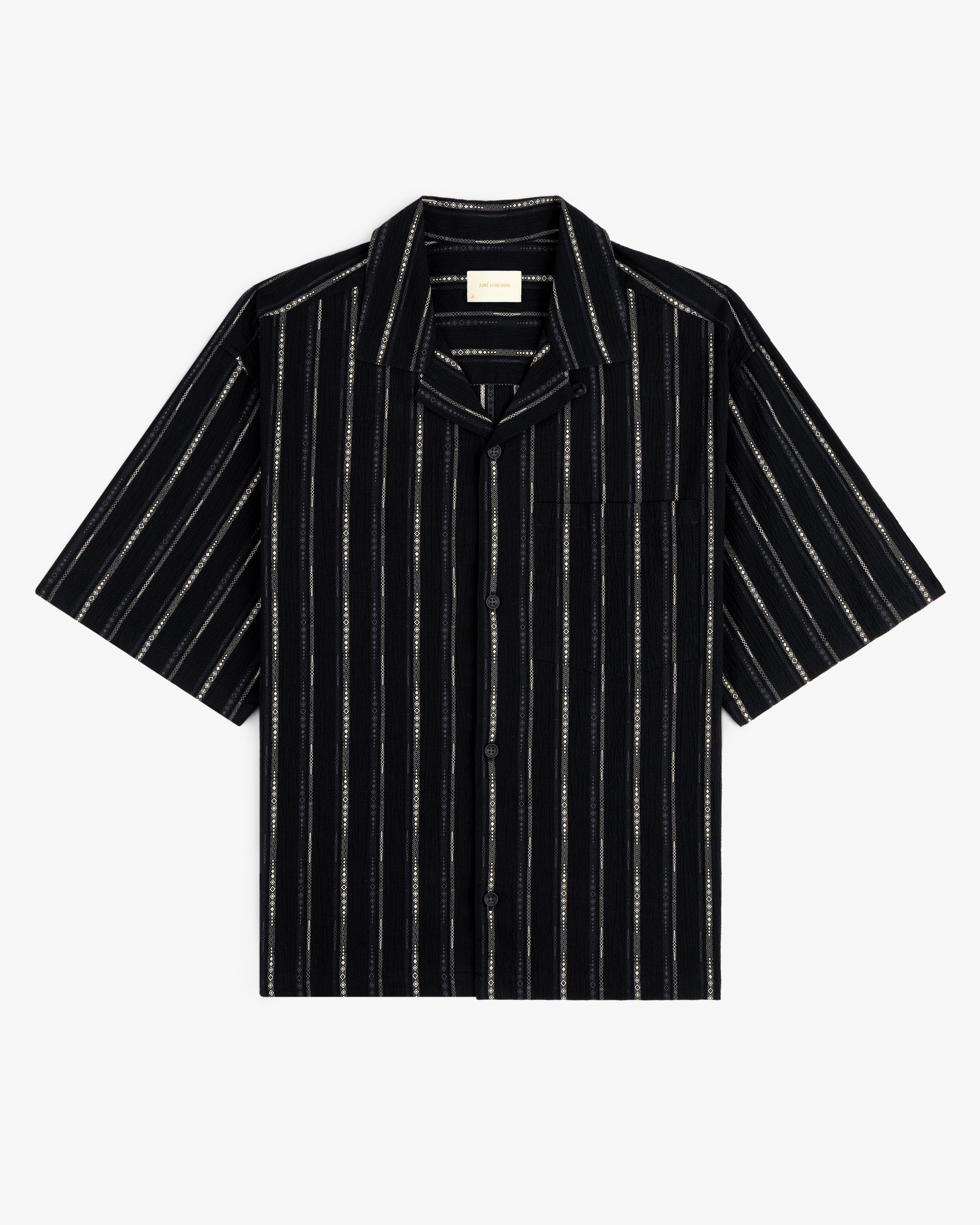 Cropped Jacquard Camp Shirt in black with white vertical stripes, chest pocket, and short sleeves, laid flat.