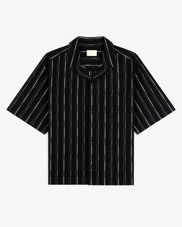 Cropped Jacquard Camp Shirt in black with white vertical stripes, chest pocket, and short sleeves, laid flat.