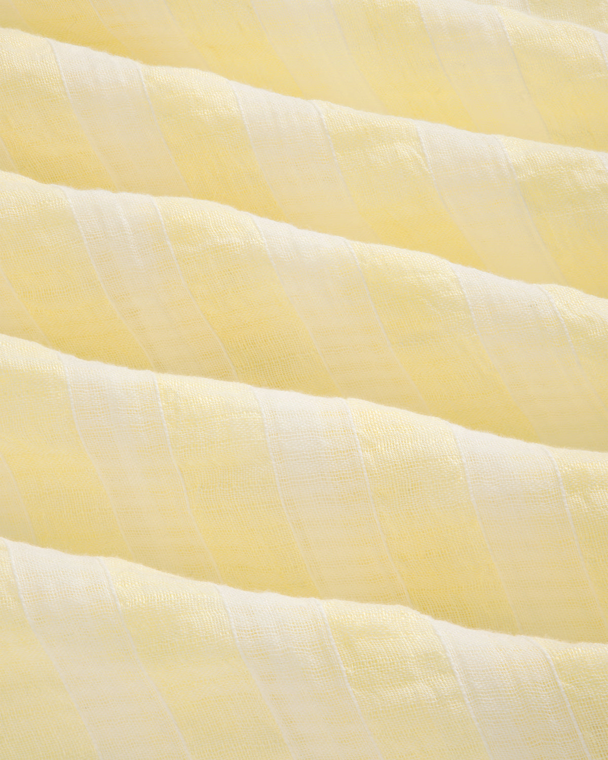 Close-up of the Linen Blend Striped Camp Shirt featuring light yellow and white stripes with a soft, textured surface.