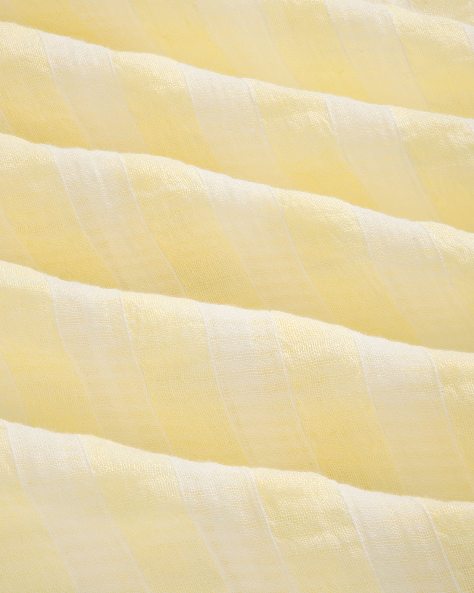 Close-up of the Linen Blend Striped Camp Shirt featuring light yellow and white stripes with a soft, textured surface.