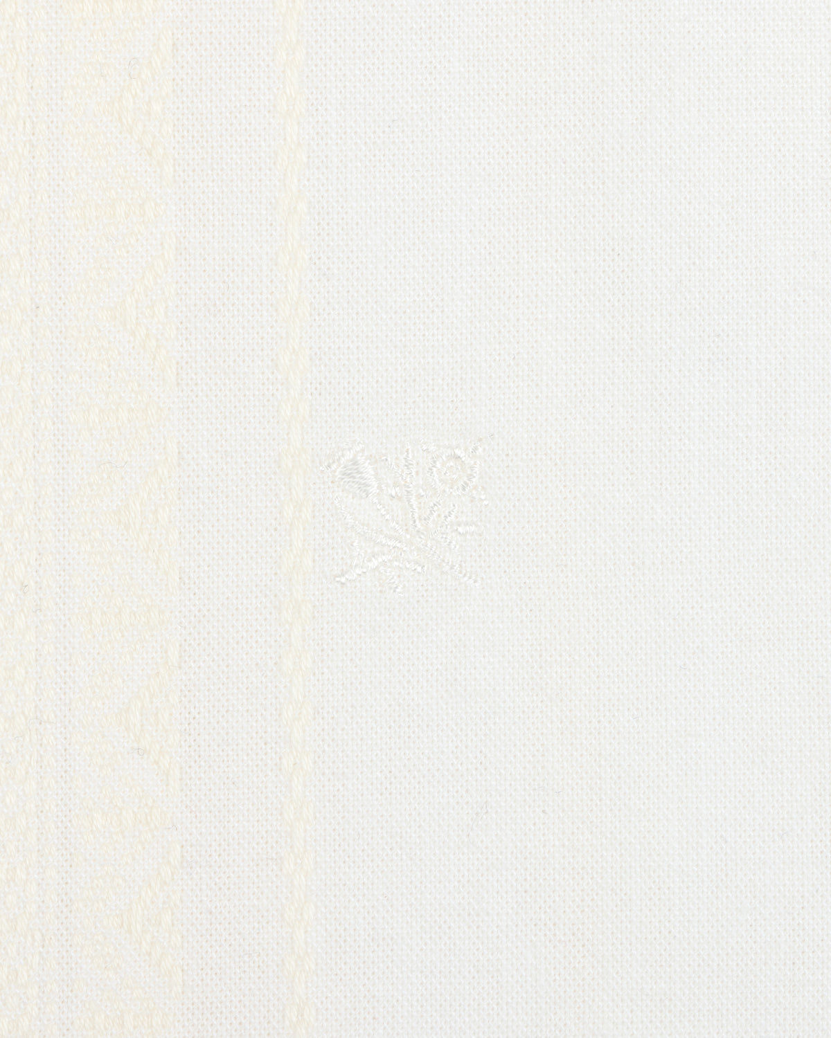 Close-up of the Jacquard Striped Tie-Front Shirt with white fabric and subtle woven geometric patterns on the left side.