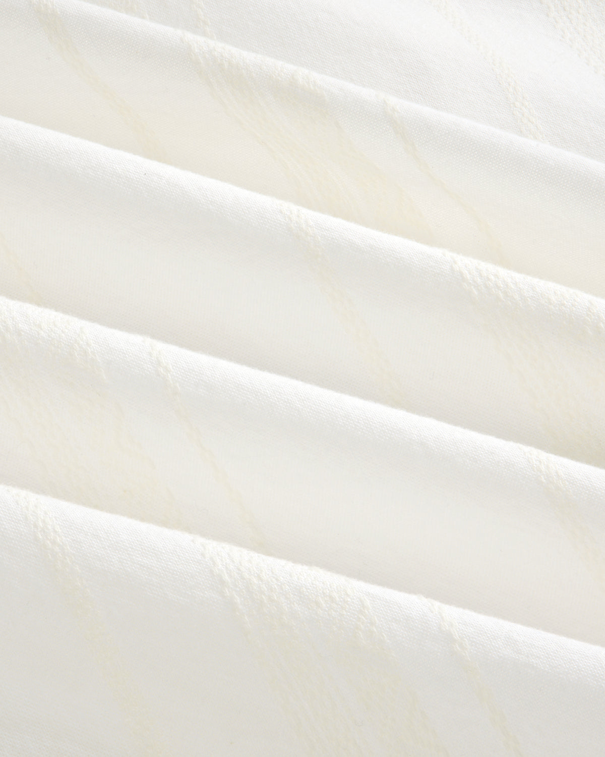 Close-up of the Jacquard Striped Tie-Front Shirt’s soft white fabric with subtle diagonal textured lines.