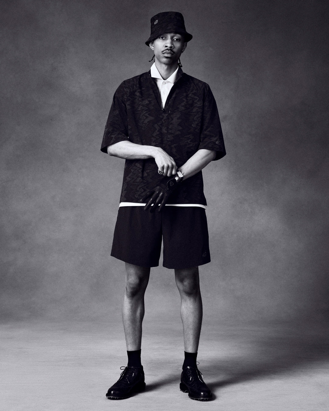 A man in the ALD Golf Nylon Quarter Zip Pullover stands against a gray studio backdrop.