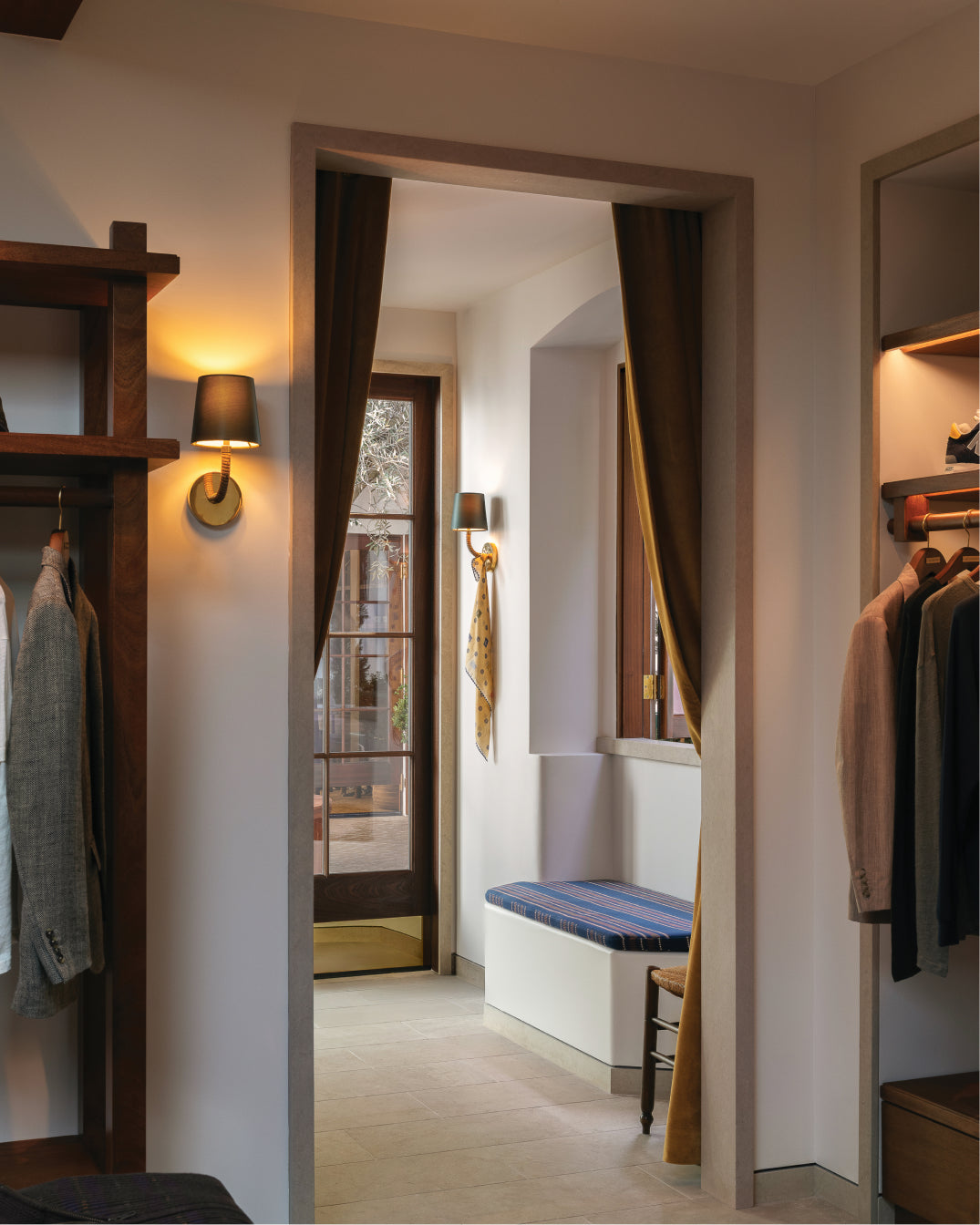 Los Angeles flagship interior with clothes and shelves, leading to a hallway.