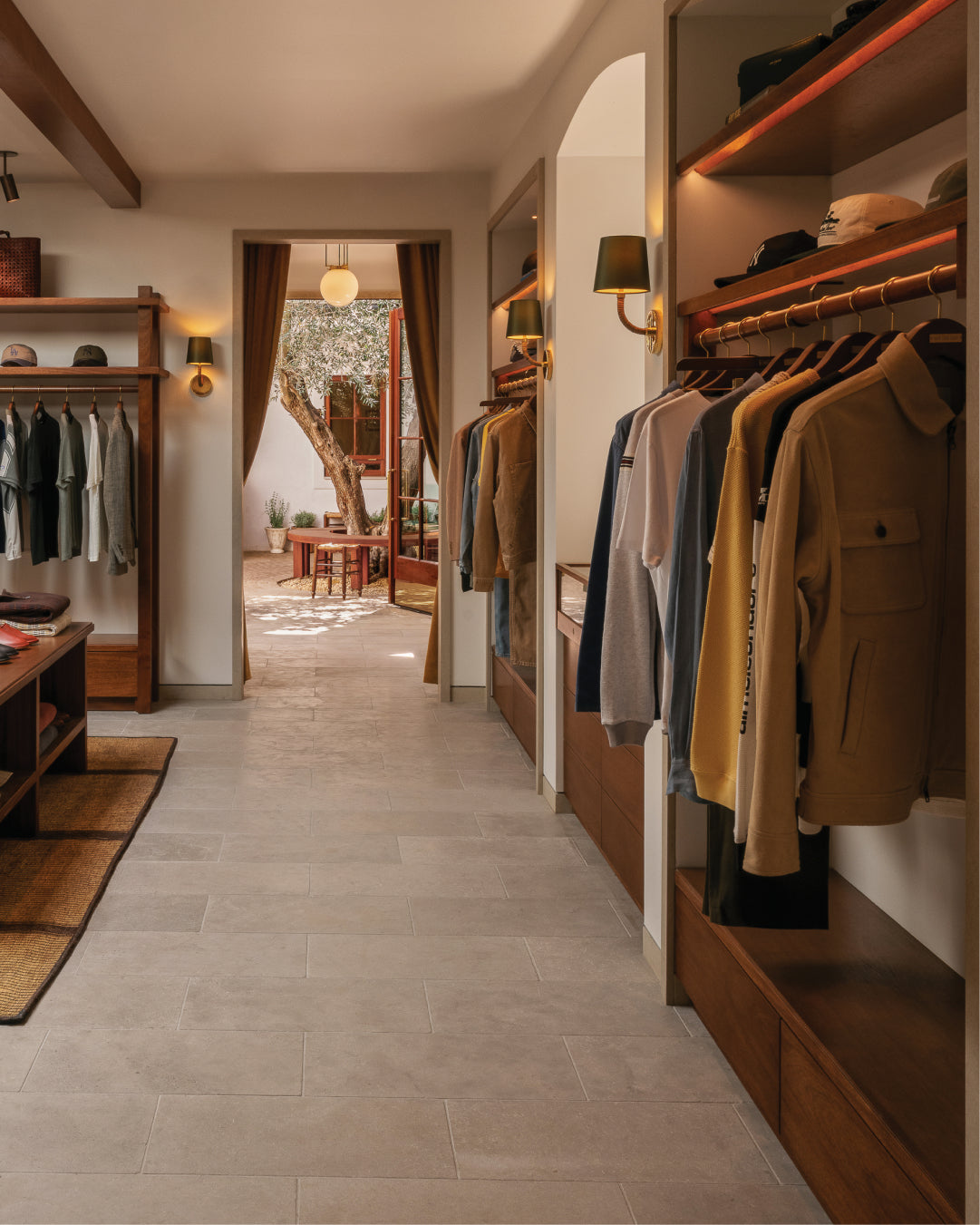 interior of Los Angeles Flagship with racks of clothes and a view into another room.