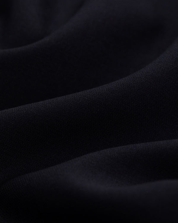 Close-up of Tropical Wool Suit Trouser fabric with soft folds and a smooth, wavy texture.