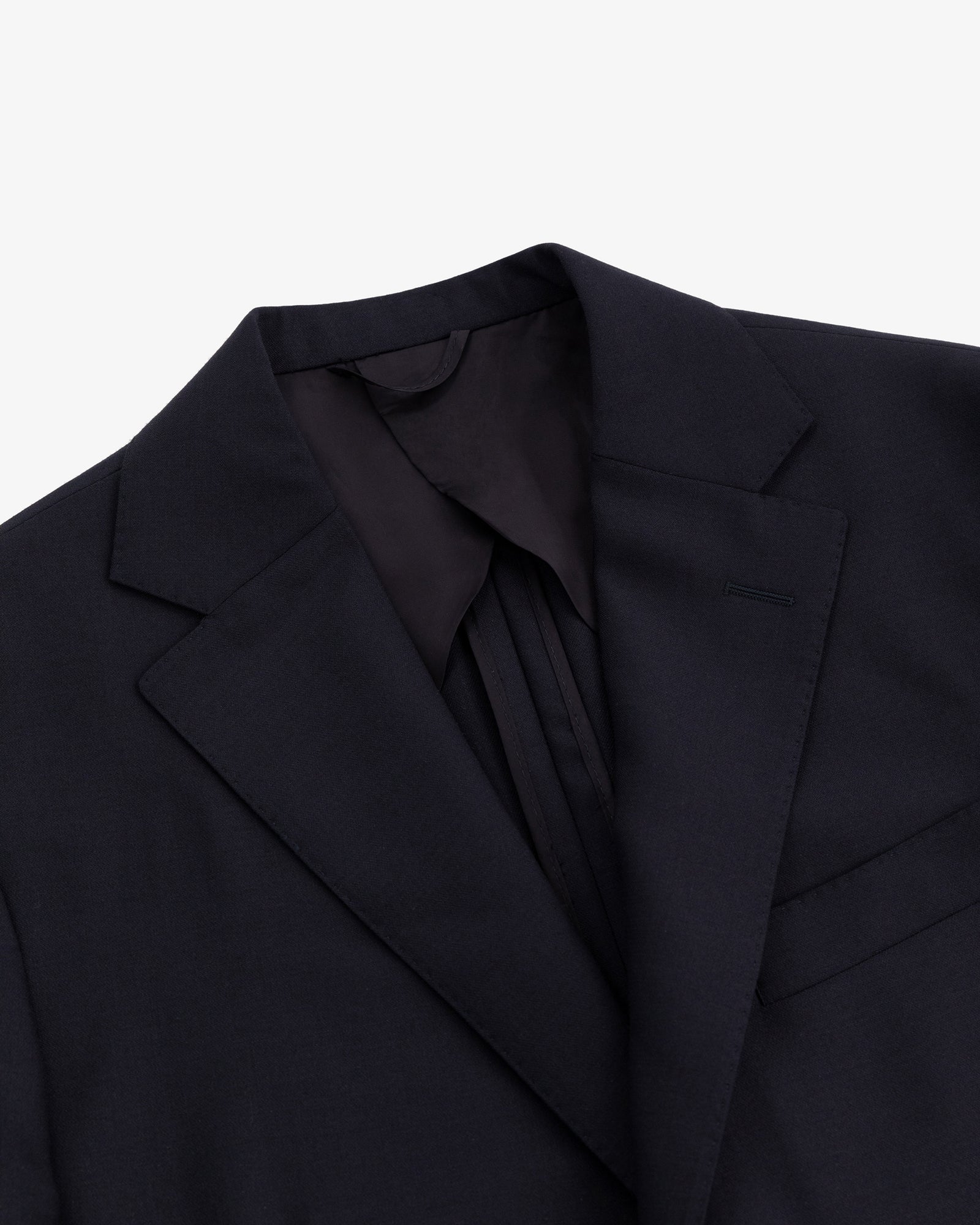 Close-up of the Tropical Wool Suit Jacket featuring a notched lapel and chest pocket on a white background.