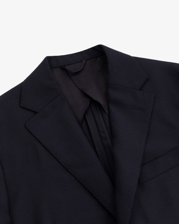 Close-up of the Tropical Wool Suit Jacket featuring a notched lapel and chest pocket on a white background.