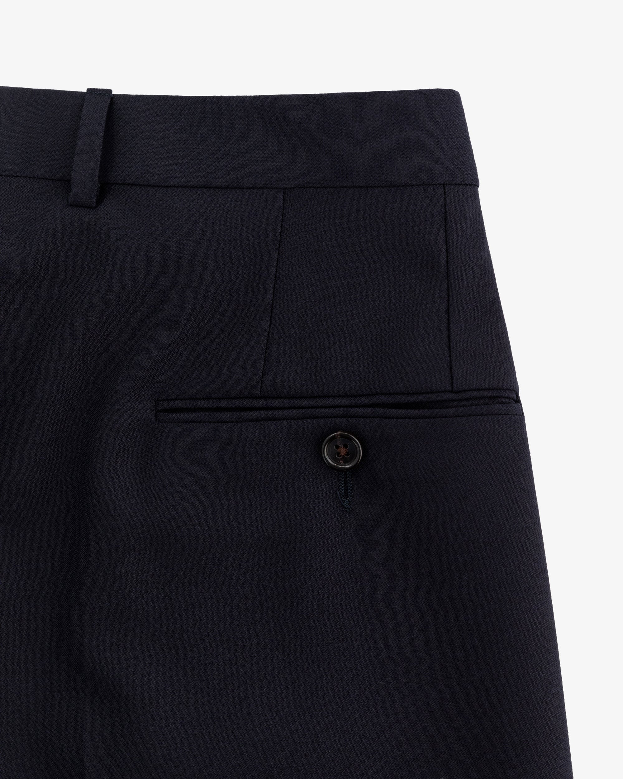 Close-up of Tropical Wool Suit Trouser showing waistband, belt loop, and back pocket with button closure.