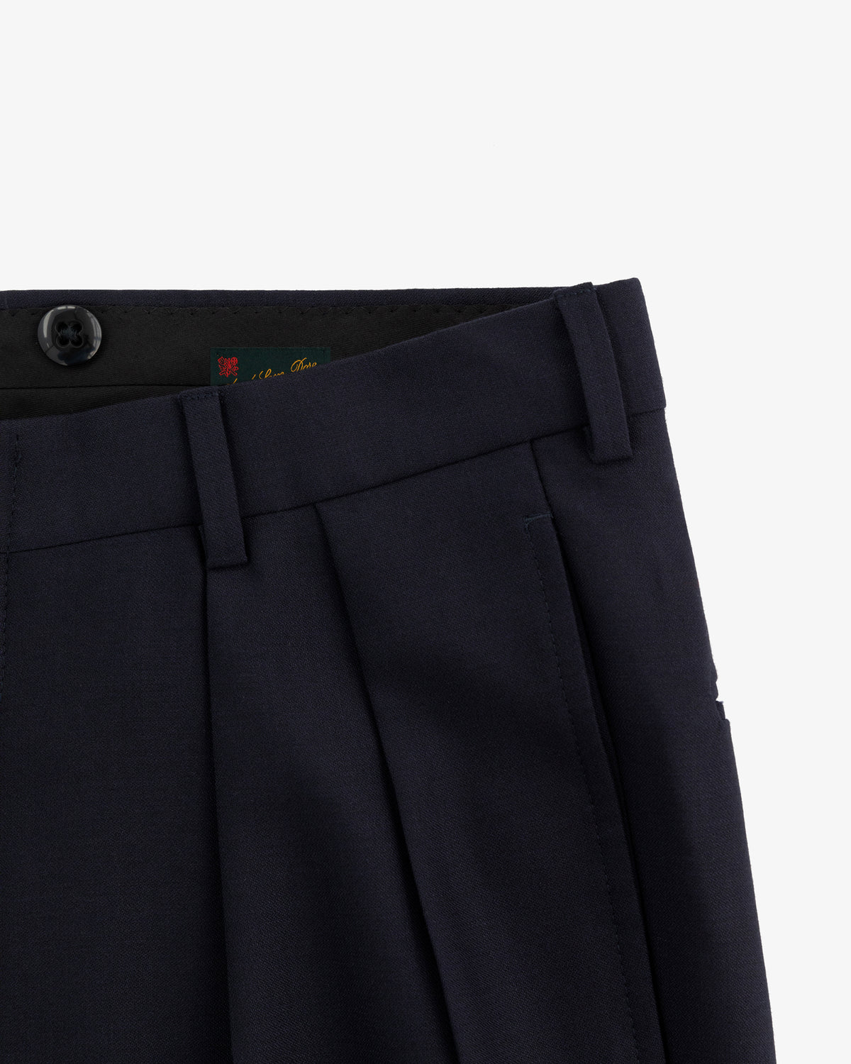 Close-up of the waist and upper leg of Tropical Wool Suit Trouser in navy with pleats, button, and belt loops.