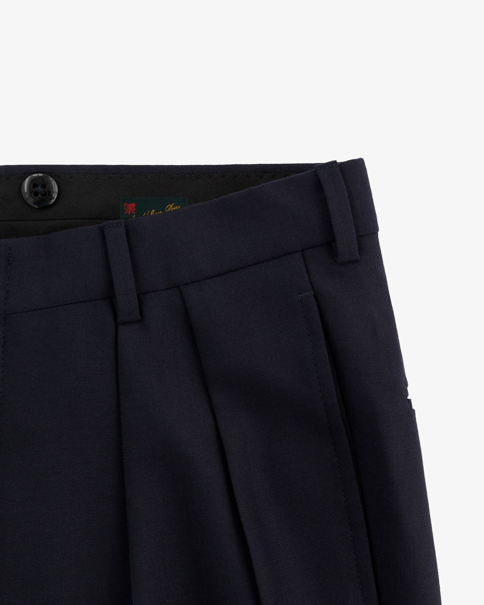 Close-up of the waist and upper leg of Tropical Wool Suit Trouser in navy with pleats, button, and belt loops.