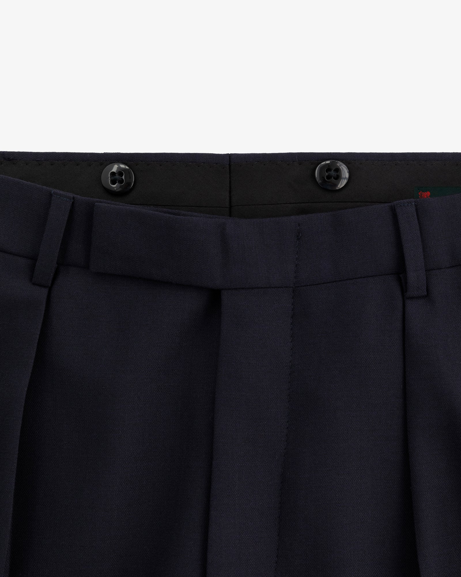 Close-up of the waistband and top front of Tropical Wool Suit Trouser in navy with belt loops and two black buttons.