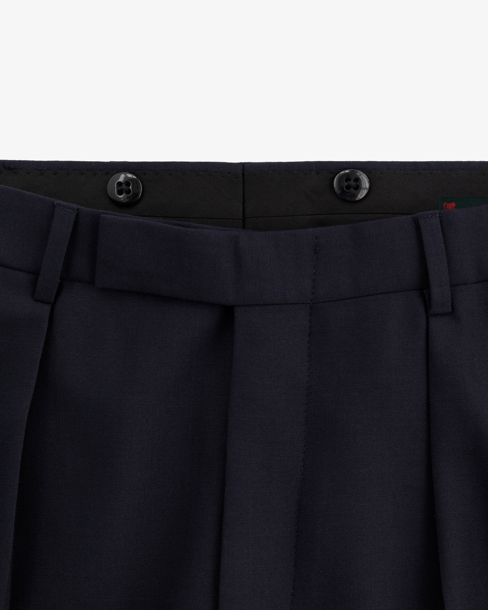 Close-up of the waistband and top front of Tropical Wool Suit Trouser in navy with belt loops and two black buttons.