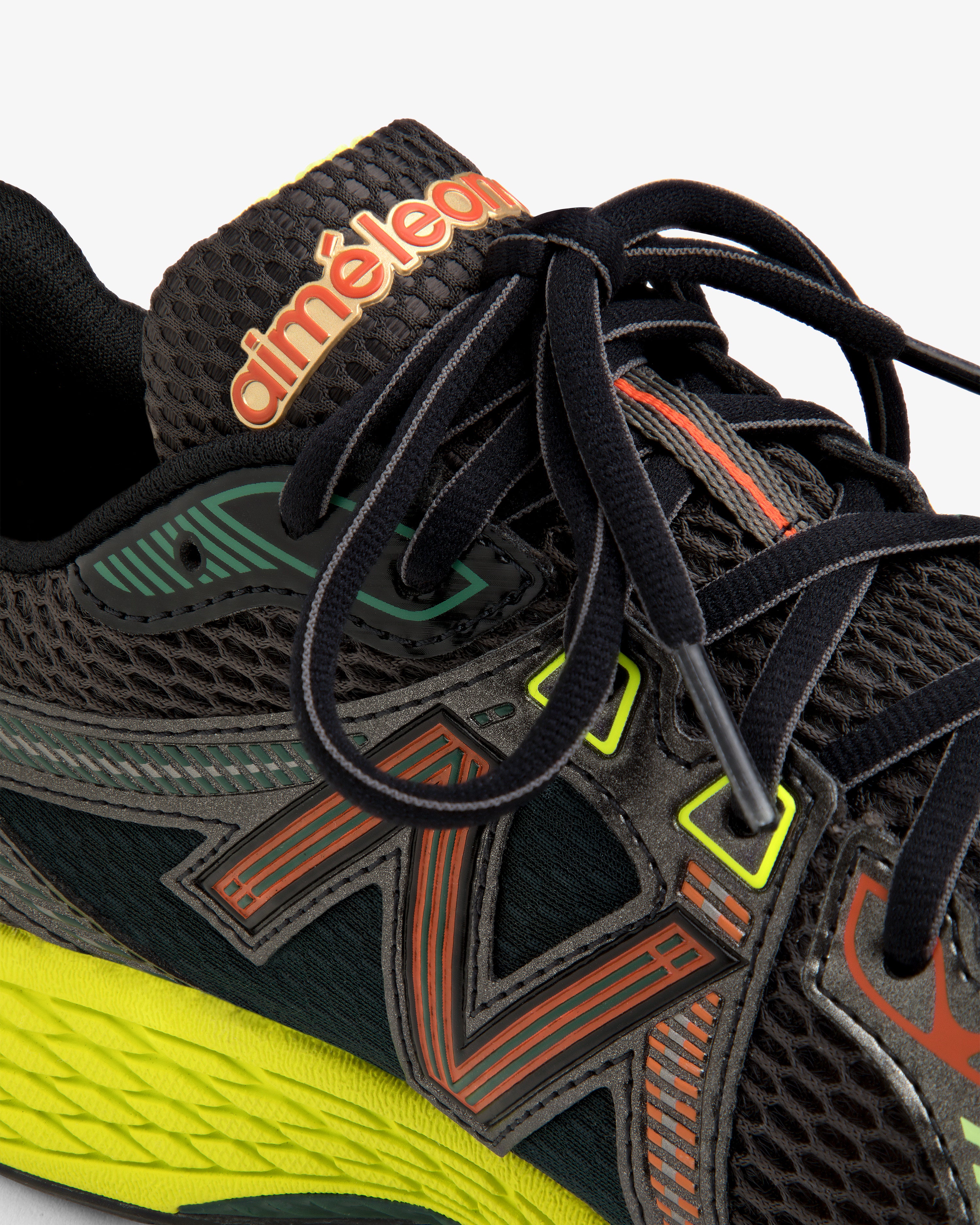 Close-up of the ALD / New Balance 860v2, a black sneaker with colorful accents, black laces, and branded tongue.