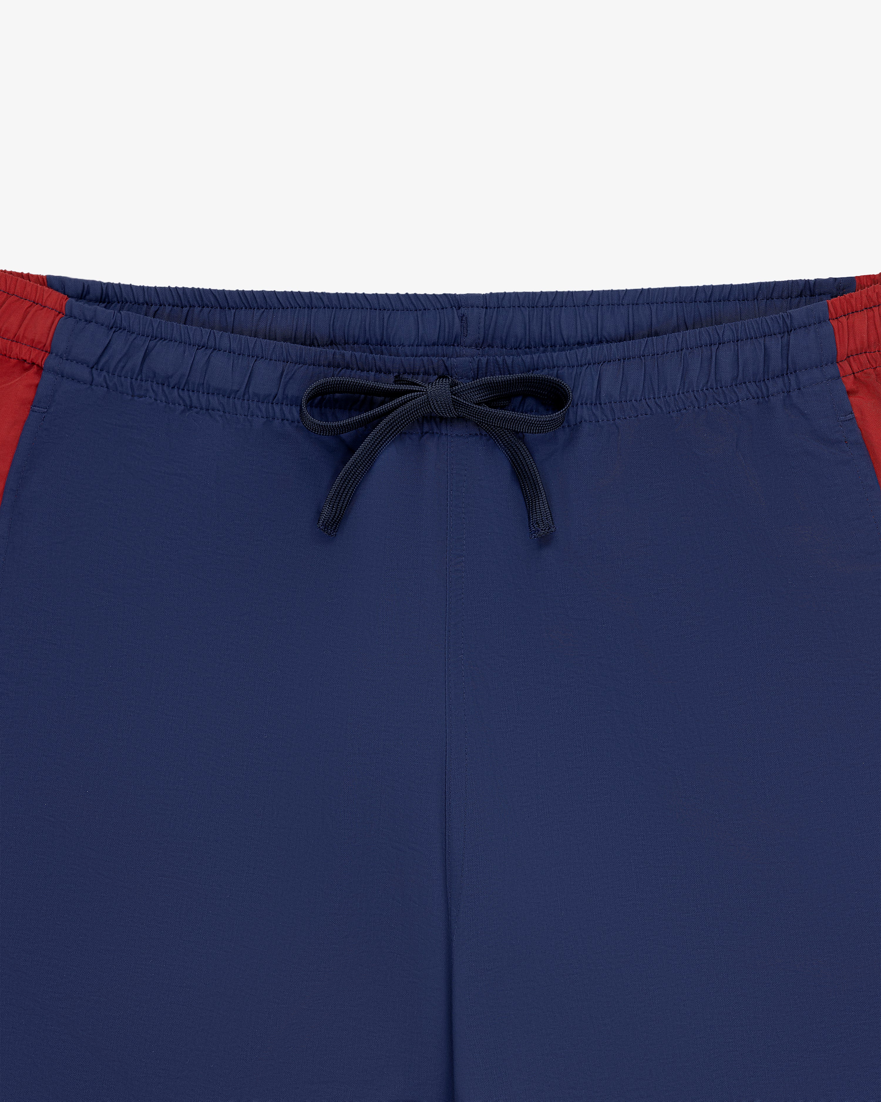 Colorblock Track Pant with black drawstring and red panels, displayed on a white background.