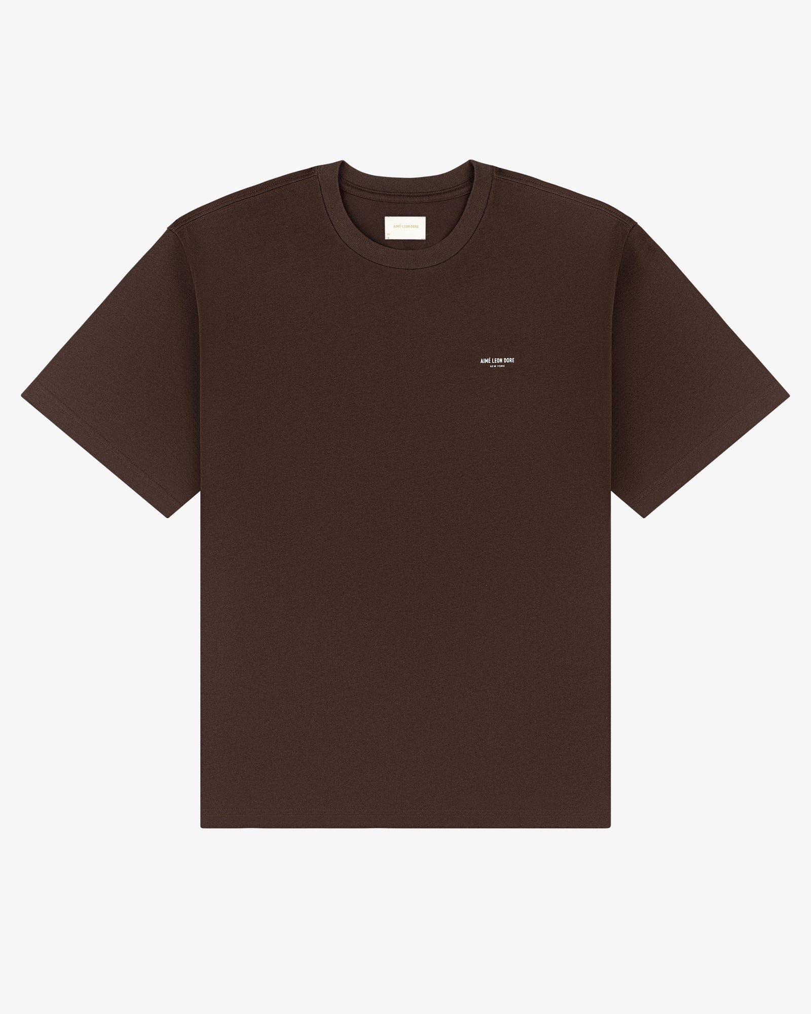 Micro Logo Tee in dark brown with a small white logo on the left chest, shown on a white background.