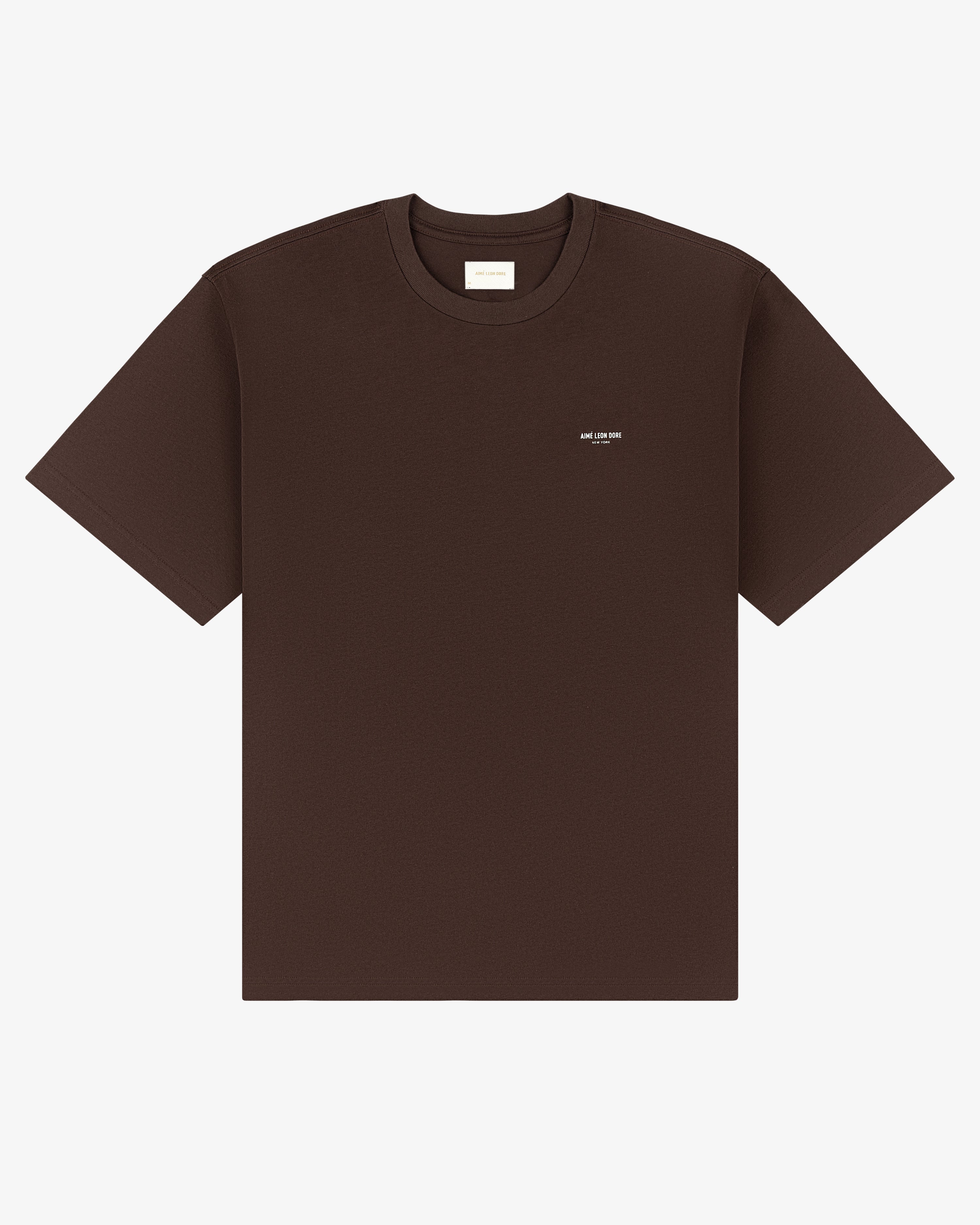 Micro Logo Tee in dark brown with a small white logo on the left chest, shown on a white background.
