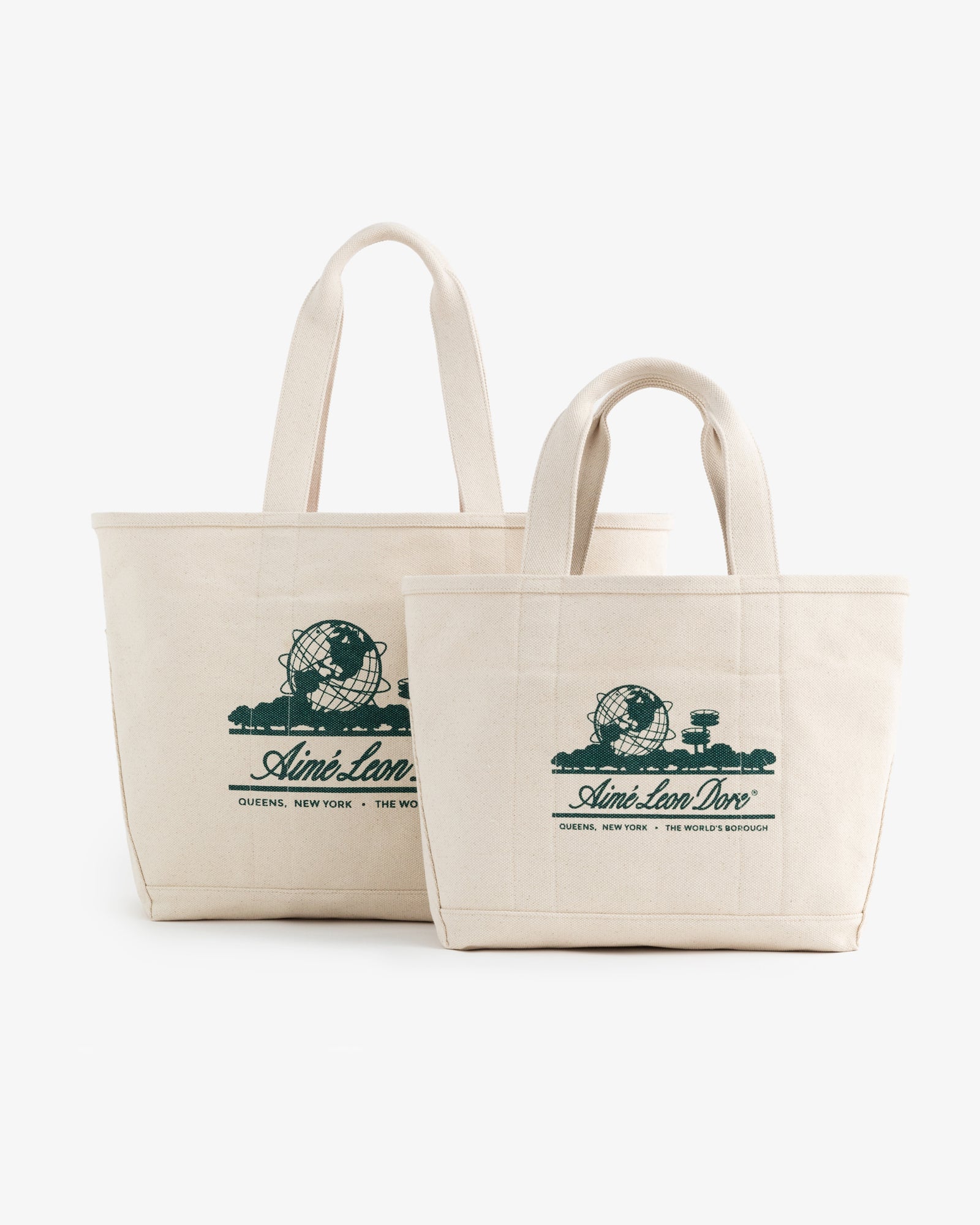 Two cream-colored Small Unisphere Tote Bags with green Aimé Leon Dore text and globe graphics.